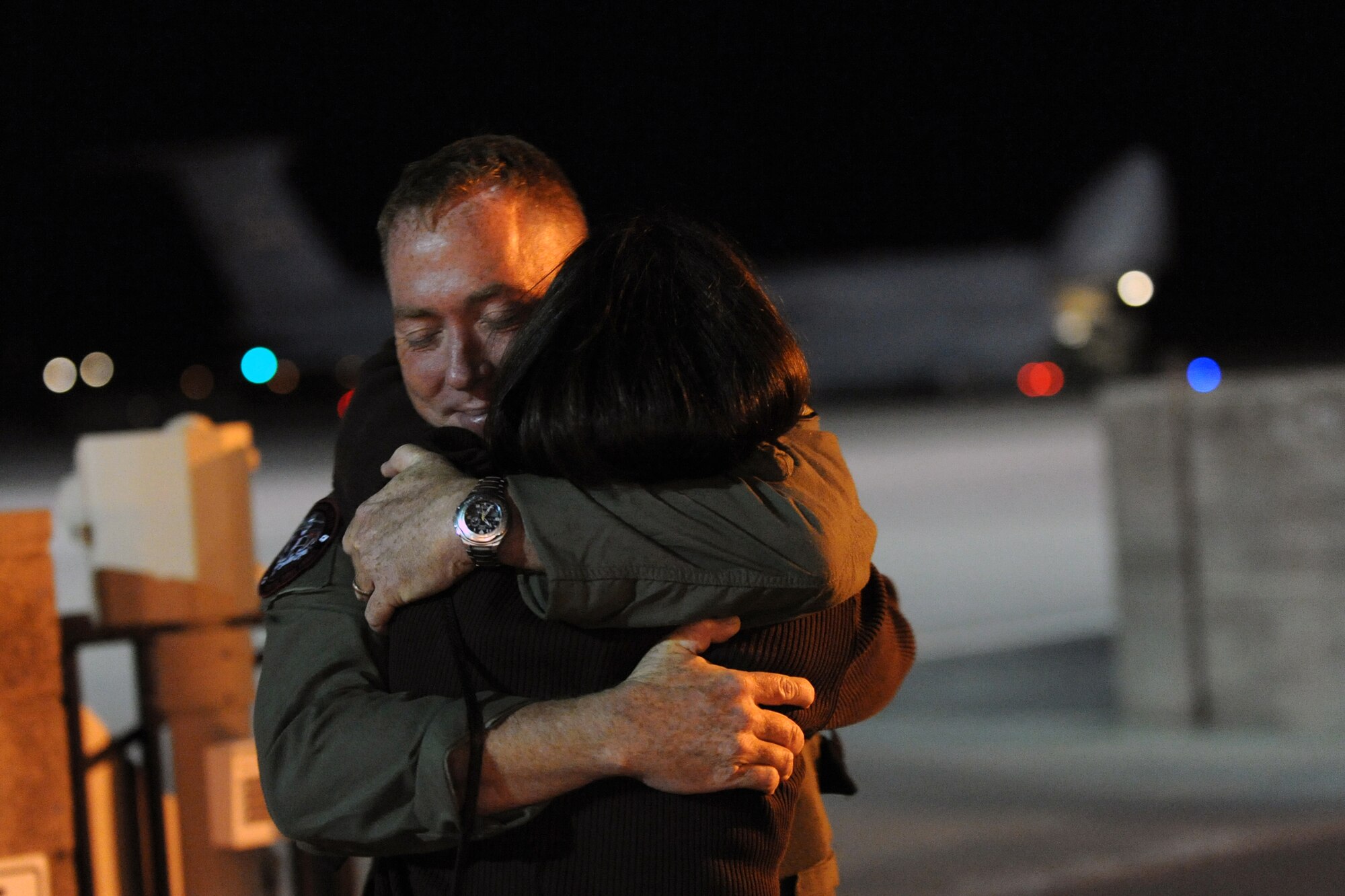Nellis AIR FORCE BASE, Nev. -- Major Jeffery Bright, 11th Reconnaissance Squadron, embraces his wife Diane, on the Nellis AFB flightline March 5. Major Bright recently returned from supporting Operation United Response. He served as the detachment commander for RQ-1 Predator operations at Puerto Rico's Rafael Hernandez Airport. (U.S. Air Force photo by Tech. Sgt. Michael R. Holzworth)