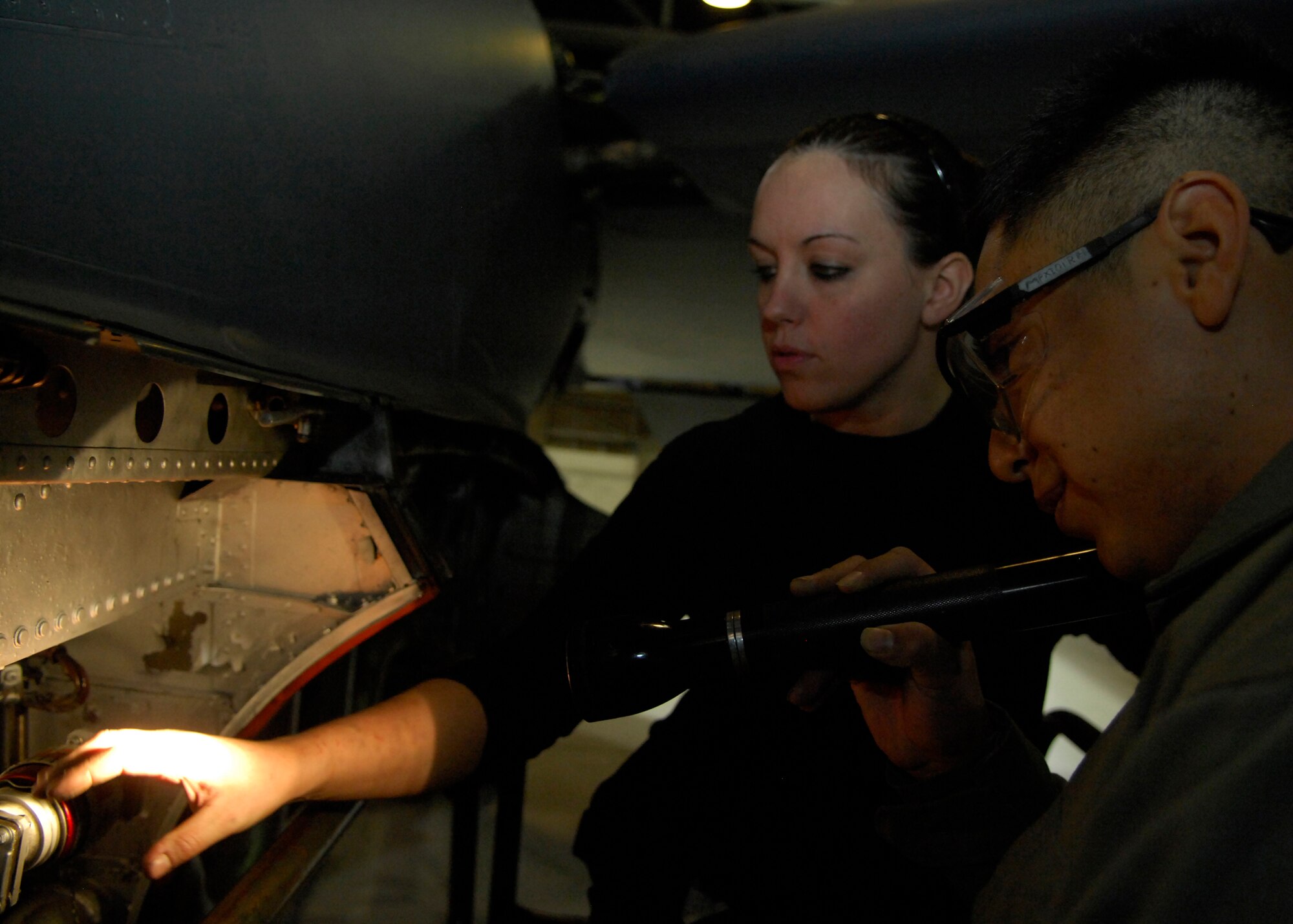MINOT AIR FORCE BASE, N.D. -- Staff Sgt. Denise Chavez, 5th Maintenance Squadron aerospace propulsion craftsman, and Airman 1st Class Fernando Montenegro, 5th Maintenance Squadron aircraft structural maintenance apprentice, inspects a B-52H Stratofortress for corrosion March 5. Checking for corrosion is an integral part to ensure aircraft are safe and run properly. (U.S. Air Force photo by Airman 1st Class Ashley N. Avecilla)