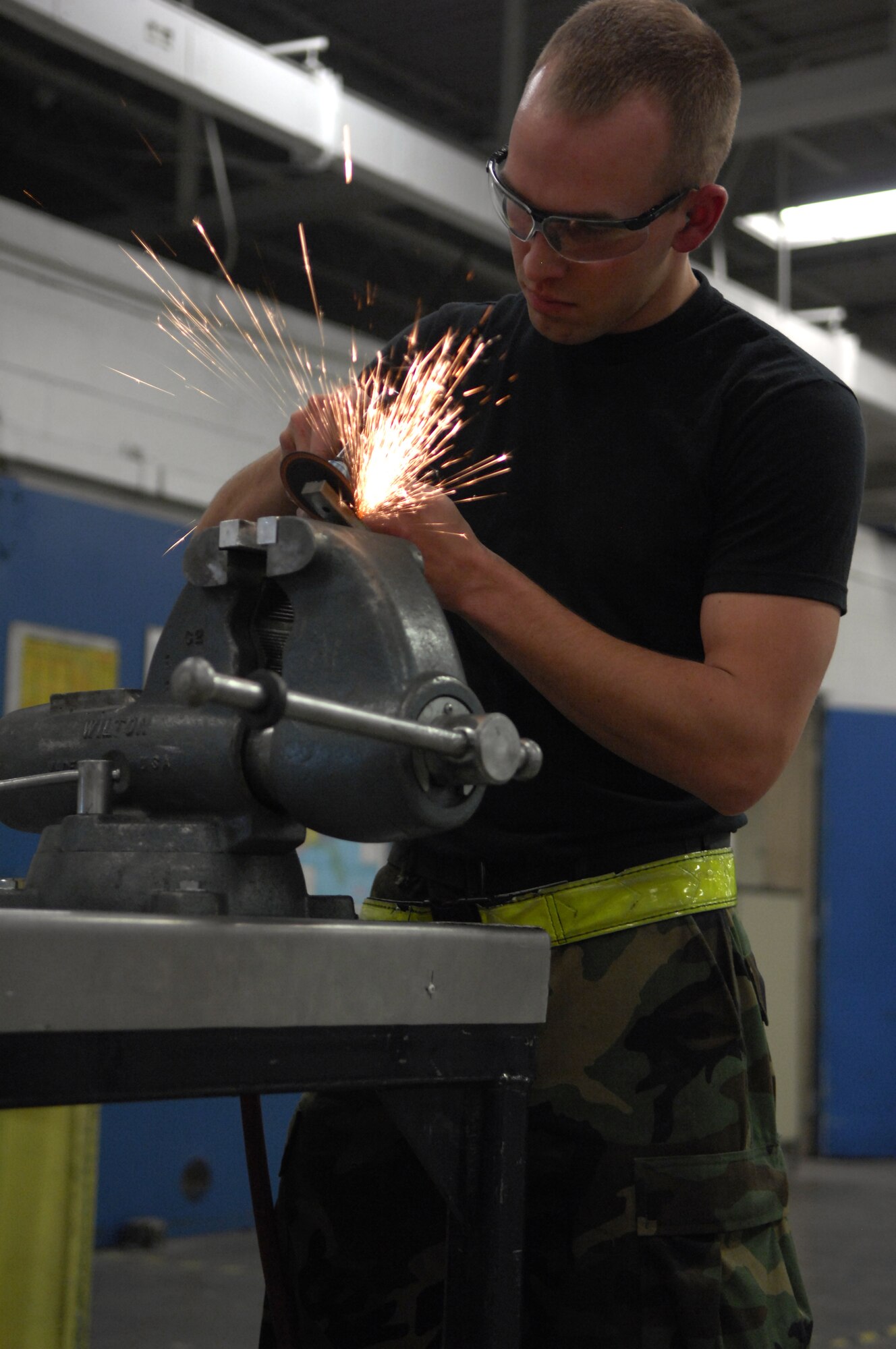 MINOT AIR FORCE BASE, N.D. -- Airman Brayden Foley, 5th Maintenance Squadron aircraft structural maintenance apprentice, trims a longeron bracket for a piece of lower body cowling that is in need of repair at the 5th MXS building March 5. Airman Brayden is one of many members of Team Minot who contributes his knowledge and skills to help keep the mission running. (U.S. Air Force photo by Airman 1st Class Ashley N. Avecilla)