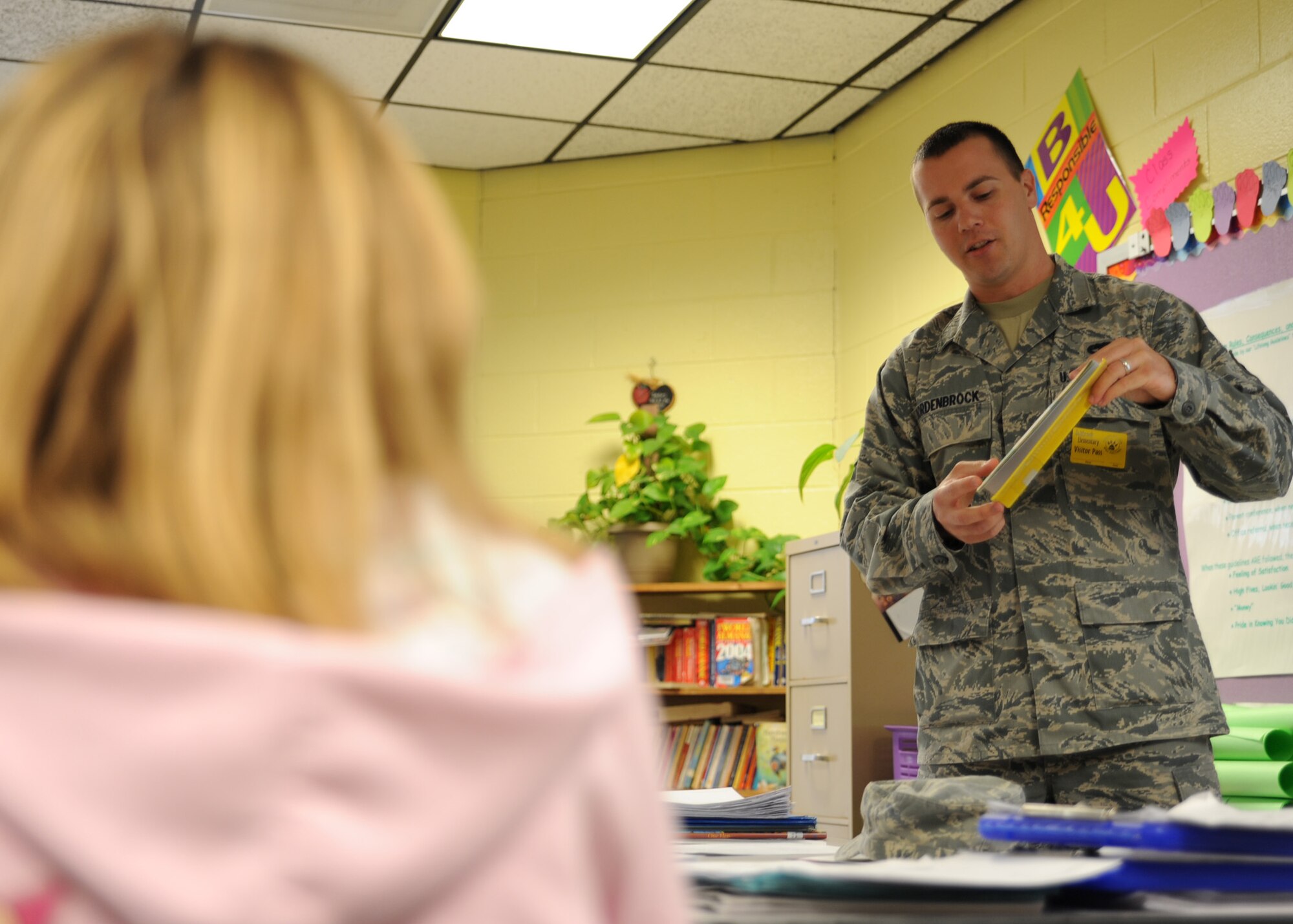A student listens as Airman 1st Class Nick Kordenbrock reads a Dr. Seuss book to her class March 2 at Oakbrook Elementary School in Ladson. Seven Airmen from Joint Base Charleston visited the school to participate in the nationwide Read Across America Week, which also celebrated Dr. Seuss' birthday. Airman Kordenbrock is an analysis journeyman with the 437th Maintenance Operations Squadron. (U.S. Air Force photo/Senior Airman Katie Gieratz)