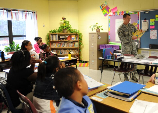 Airman 1st Class Nick Kordenbrock reads to a group of students March 2 at Oakbrook Elementary School in Ladson. Airman Kordenbrock was one of seven Airmen from Joint Base Charleston who participated in reading to elementary school students for the nationwide Read Across America Week. Airman Kordenbrock is an analysis journeyman with the 437th Maintenance Operations Squadron. (U.S. Air Force photo/Senior Airman Katie Gieratz)