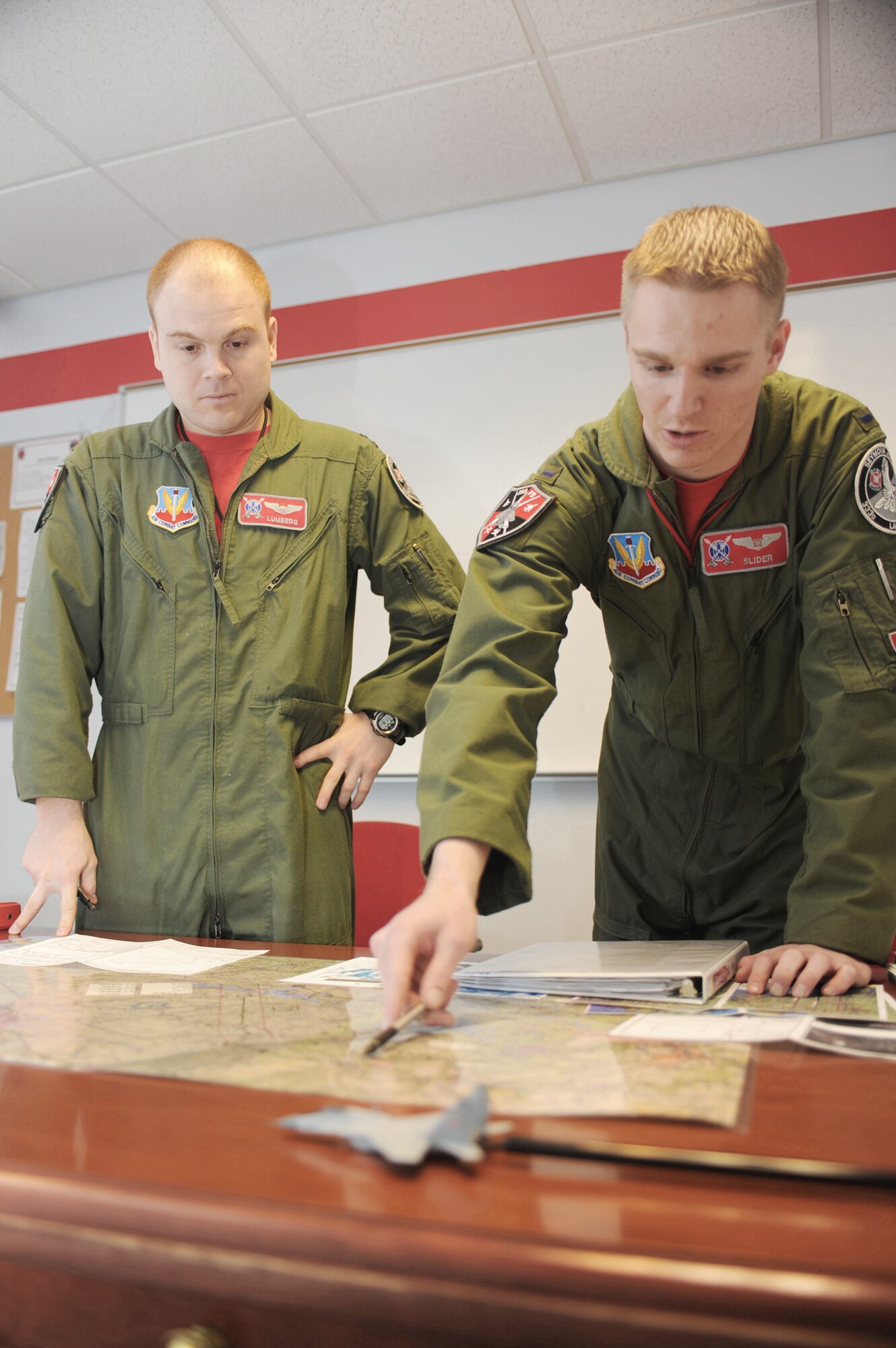 1st Lt. Clayton Couch gives a low-level brief to Capt. Tom Bean for their flight Feb. 5, 2010, at Seymour Johnson AFB, N.C. Lieutenant Couch is weapons systems officer student and Captain Bean is a student pilot attending the 333rd Fighter Squadron Basic Course. (U.S. Air Force photo/Tech. Sgt. Lesley Waters) 