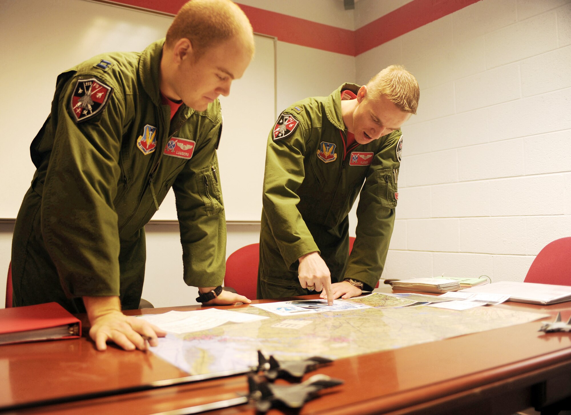 1st Lt. Clayton Couch discusses a designation game plan with Capt. Tom Bean for their upcoming flight Feb. 5, 2010, at Seymour Johnson Air Force Base, N.C. Lieutenant Couch is weapons systems officer student and Captain Bean is a student pilot attending the 333rd Fighter Squadron Basic Course. (U.S. Air Force photo/Tech. Sgt. Lesley Waters)