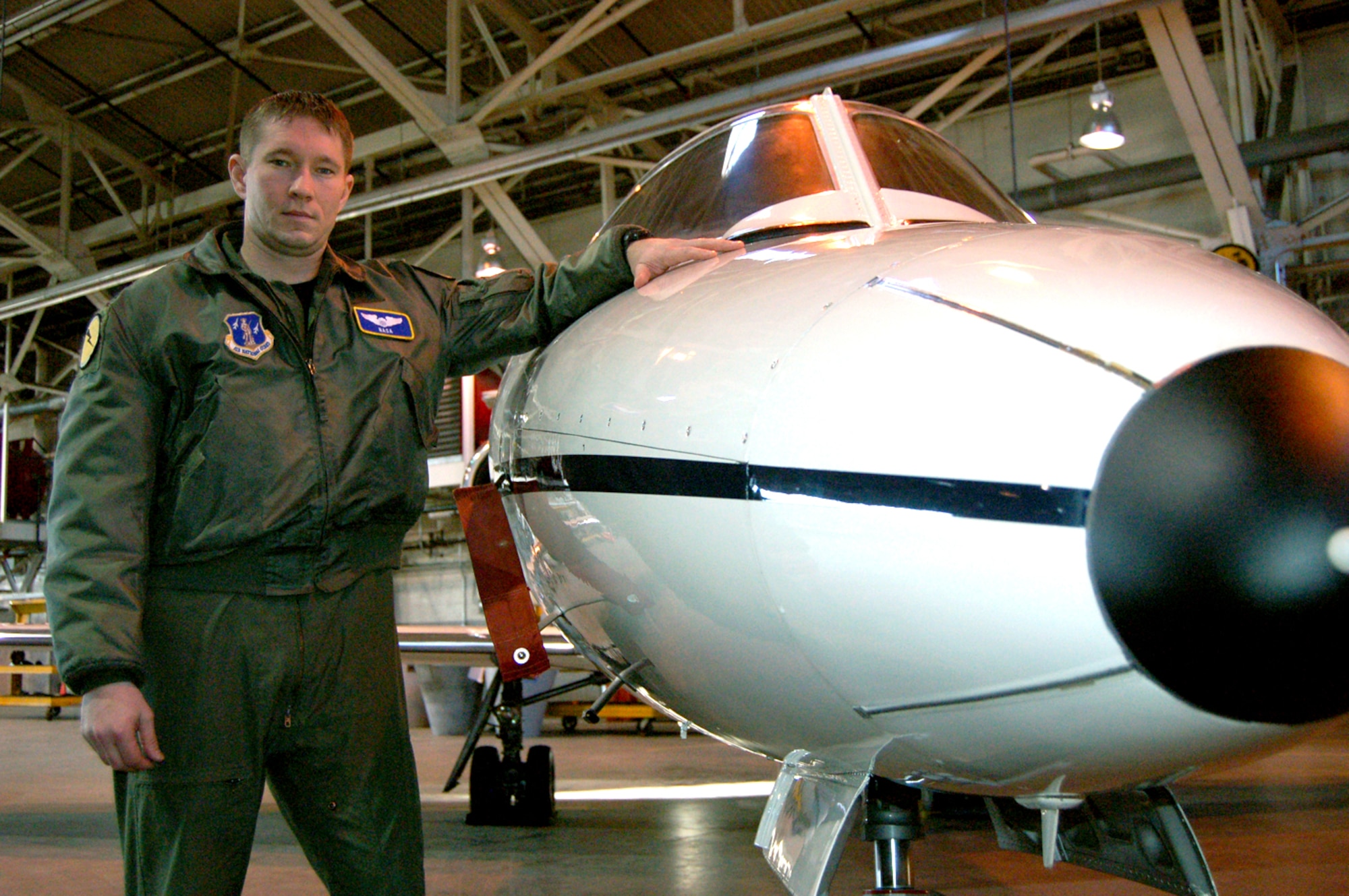 Capt. Chris “NASA” Thiesing, standardization and evaluation liaison and C-21 pilot for the 118th Airlift Squadron, stands next to a C-21 in the main hangar at Bradley Air National Guard Base, East Granby, Conn. Thiesing originally joined the Conn. Air National Guard as an enlisted Airman working in intelligence and became a pilot after achieving a bachelor’s degree. Thiesing said he wants guardsmen to know that being a traditional guardsman affords you the opportunity to get an interview to become a pilot if you meet the eligibility requirements. (U.S. Air Force photo by Tech. Sgt. Joshua Mead)