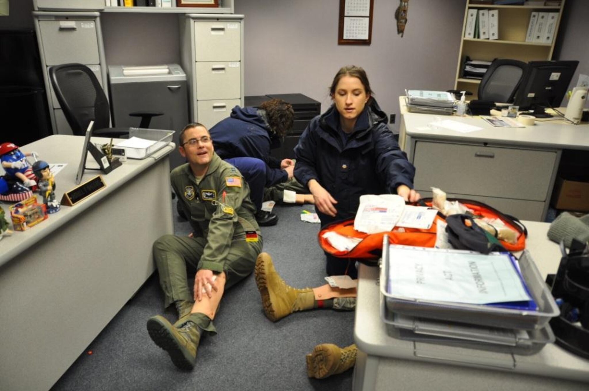 Petty Officer 3rd Class Brittany Chace and Petty Officer 1st Class Jodie White from the U.S. Coast Guard’s Air Station Cape Cod Kaehler Clinic perform medical triage Feb. 24 on Pave PAWS radar site personnel, simulated victims of sniper attack during a drill hosted by the 6th Space Warning Squadron. The 6th SWS is a geographically separated unit of the 21st Space Wing, and uses the Pave PAWS radar to guard North America’s East Coast against sea-launched and ICBMs. (U.S. Air Force photo/Master Sgt. Scott Crossman)

