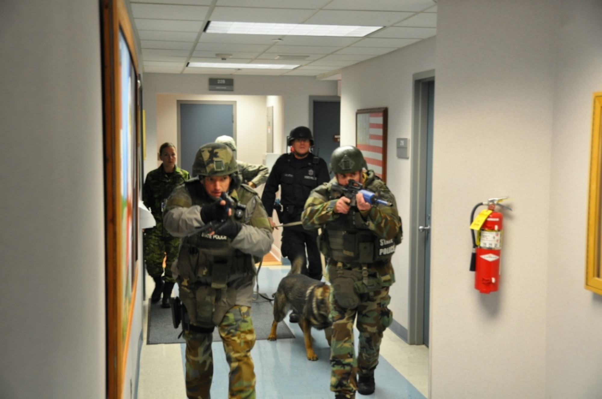 Massachusetts State Police Special Tactical Operations team members, partnering with U.S. and Canadian forces from 6th Space Warning Squadron, as well as MSP Bourne Barracks K-9 handler Sgt. Robert McCarthy and his dog, Xander, tracked a pretend sniper inside the Pave PAWS radar facility during a NIMS drill Feb. 24. The 6th SWS is a geographically separated unit of the 21st Space Wing, and uses the Pave PAWS radar to guard North America’s East Coast against sea-launched and ICBMs. (U.S. Air Force photo/Master Sgt. Scott Crossman)


