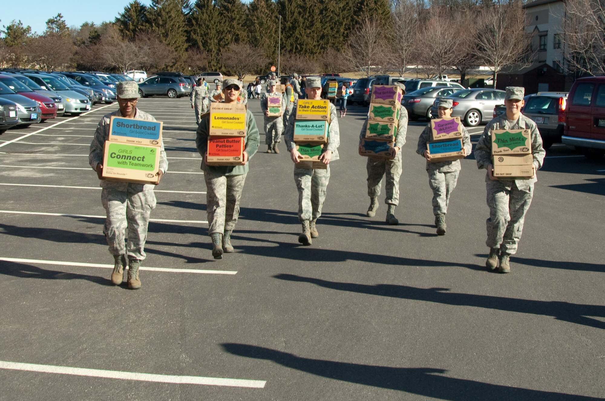Hanscom volunteers have their hands full as they unload more than 30,000 boxes of Girl Scout Cookies March 6 during Operation Cookie Drop. (U.S. Air Force photo by Rick Berry)