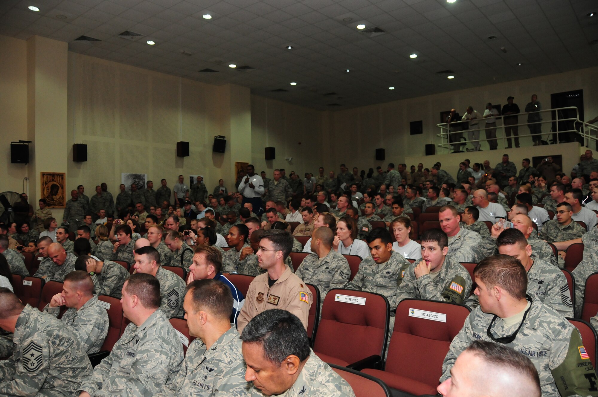 Servicemembers gather in the base theater at an undisclosed location in Southwest Asia to hear inspirational stories by "Legends of Aerospace" Bob Gilliland, U.S. Air Force Retired Brig. Gen. Steve Ritchie, U.S. Navy Retired Capt. Jim Lovell, U.S. Navy Retired Capt. Gene Cernan and Neil Armstrong during a visit March 7, 2010. During the visit, which was part of a "Legends of Aerospace" tour, the gentlemen shared their groundbreaking aviation and aerospace experiences in a panel discussion moderated by Bill Hartman. The tour, sponsored by Armed Forces Entertainment in association with Morale Entertainment and American Airlines, will be traveling to various military installations throughout Europe and Southwest Asia. (U.S. Air Force photo by Staff Sgt. Lakisha A. Croley/Released)
