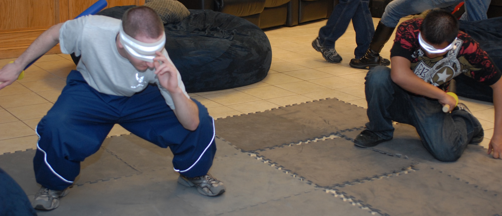 GOODFELLOW AIR FORCE BASE, Texas -- Airman 1st Class Michael Hart (left) and Airman Daniel Baird take crouching positions before a duel during the mini Star Wars convention at the Crossroads, March 5, 2010. Airmen Hart and Baird are students in the 316th Training Squadron (U.S. Air Force photo/Staff Sgt. Laura R. McFarlane) 