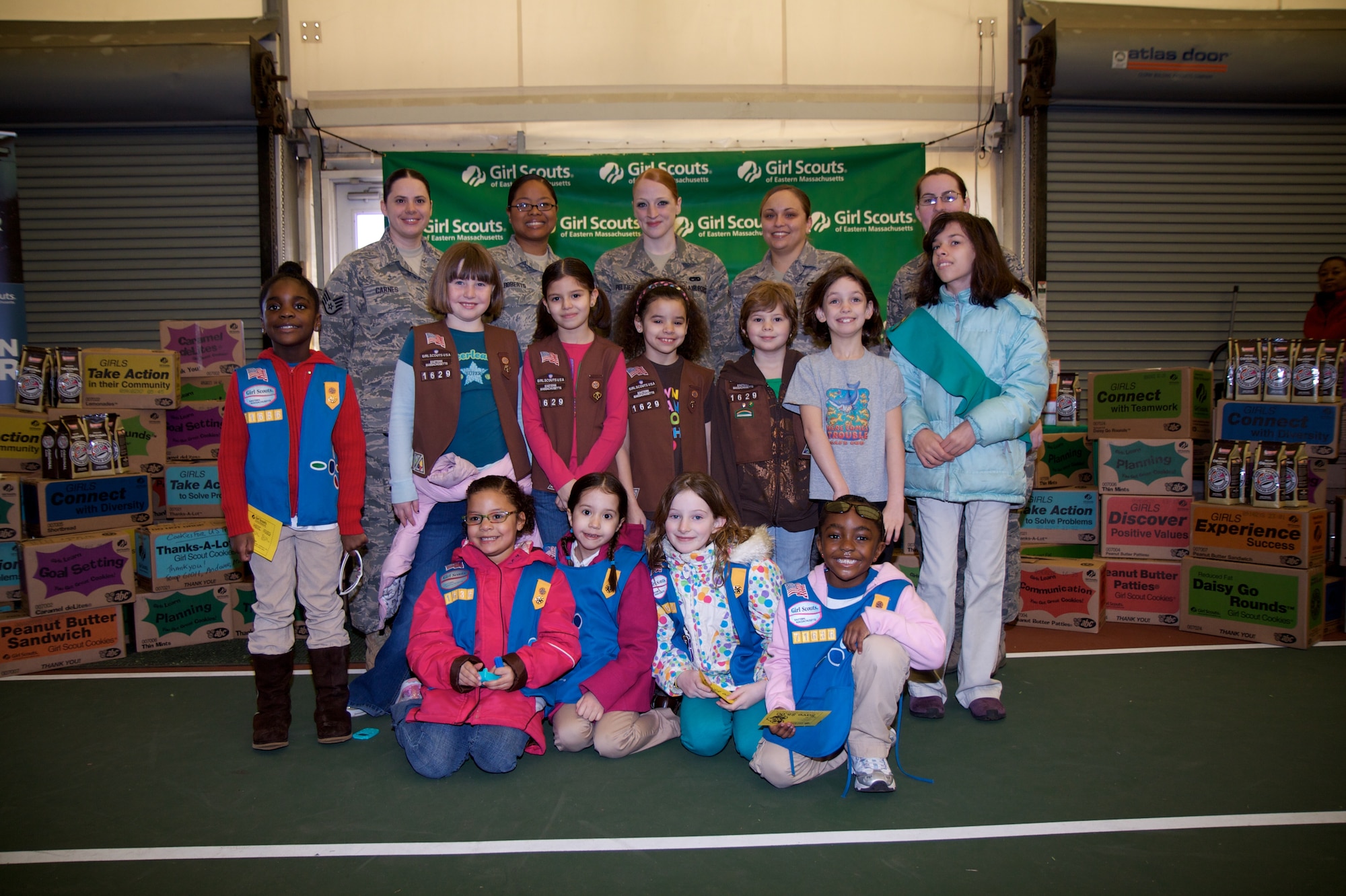 Hanscom's own Daisy, Brownie, and Junior Girl Scout troops get in on the fun of Operation Cookie Drop, posing with Air Force members. (U.S. Air force photo by Lt. Col. Loralee Manas) 
