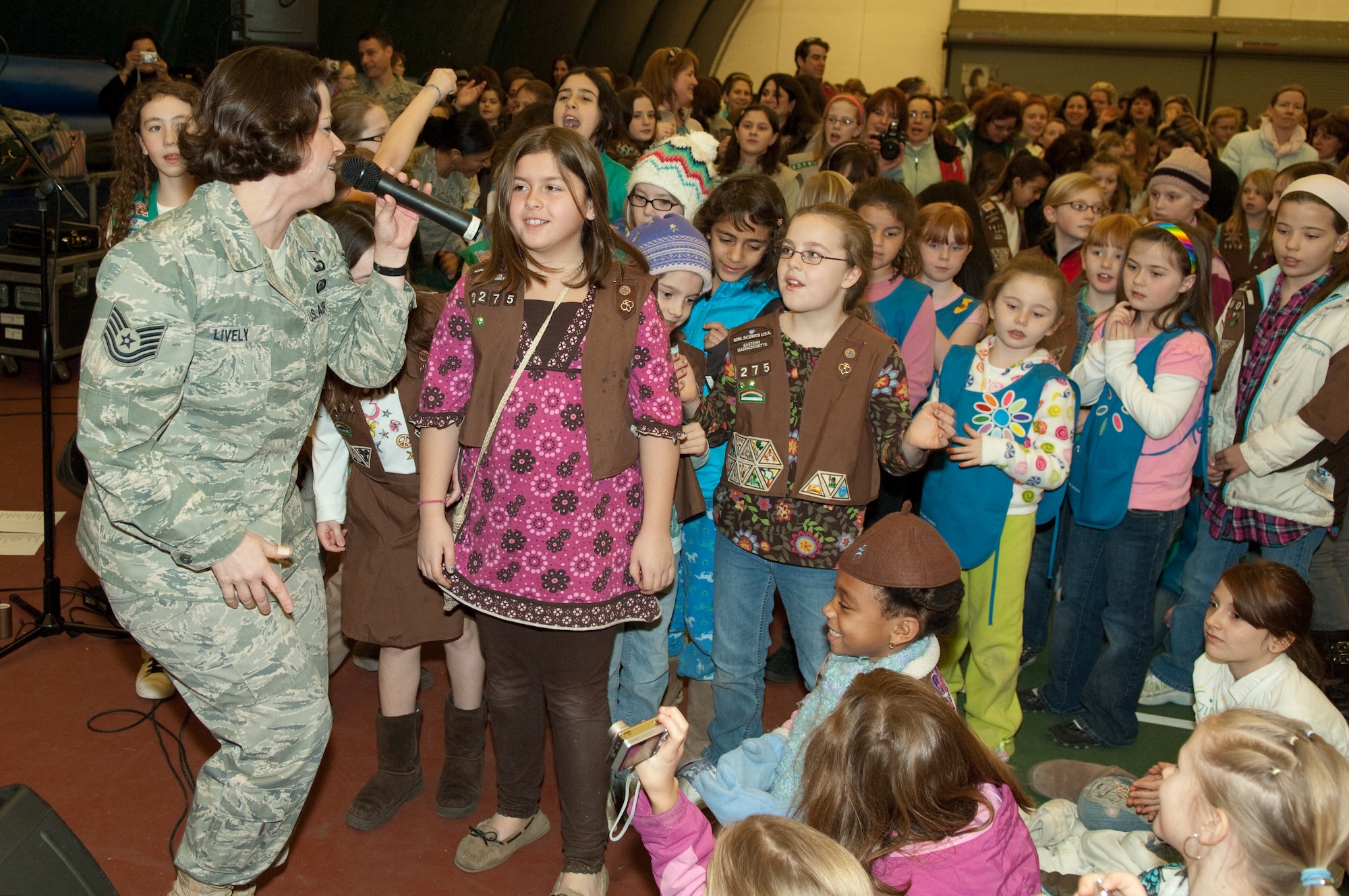 Master Sergeant Kim Lively of the Air Force Band of Liberty sings for the more than 2,000 Girl Scouts who participated in Operation Cookie Drop March 6.  (U.S. Air Force photo by Rick Berry)