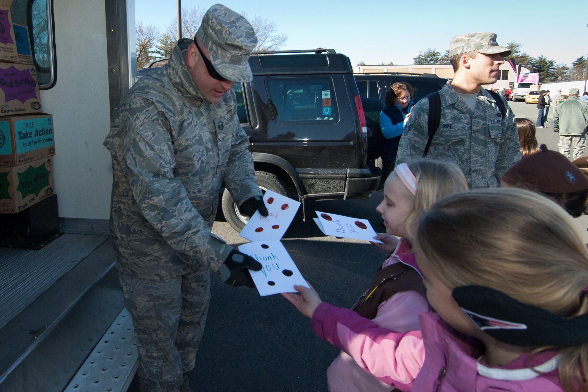 Air Force Reserve Master Sgt. Chad Obrey accepts thank you nots from Beverly, Mass. Girl Scouts during Operation Cookie Drop.  Sergeant Obrey was picking up cookies for deployed members of the 58th Aerial Port Squadron at Westover ARB, Mass.. (U.S. Air Force photo by Rick Berry)