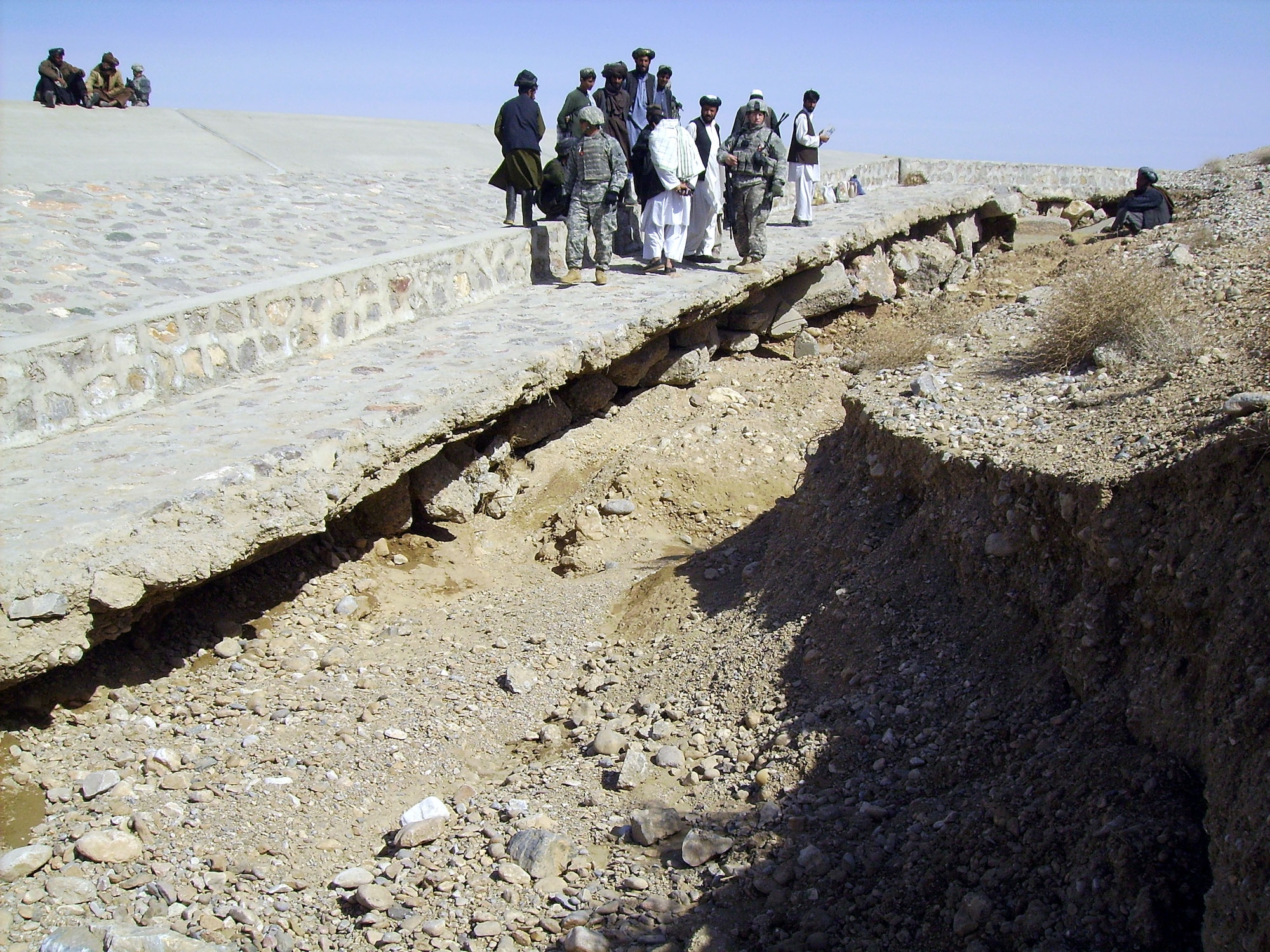 Members of PRT Zabul confer with local Afghan leaders and contractors as they assess the deterioration of one of the roads in Qalat.  This road was repaired as one of the 40 Commanders Emergency Response Program projects.  The partnership has enabled projects totaling more than $40 million throughout Zabul province.  (U.S. Air Force photo by Capt. Greg Orbino/Released)