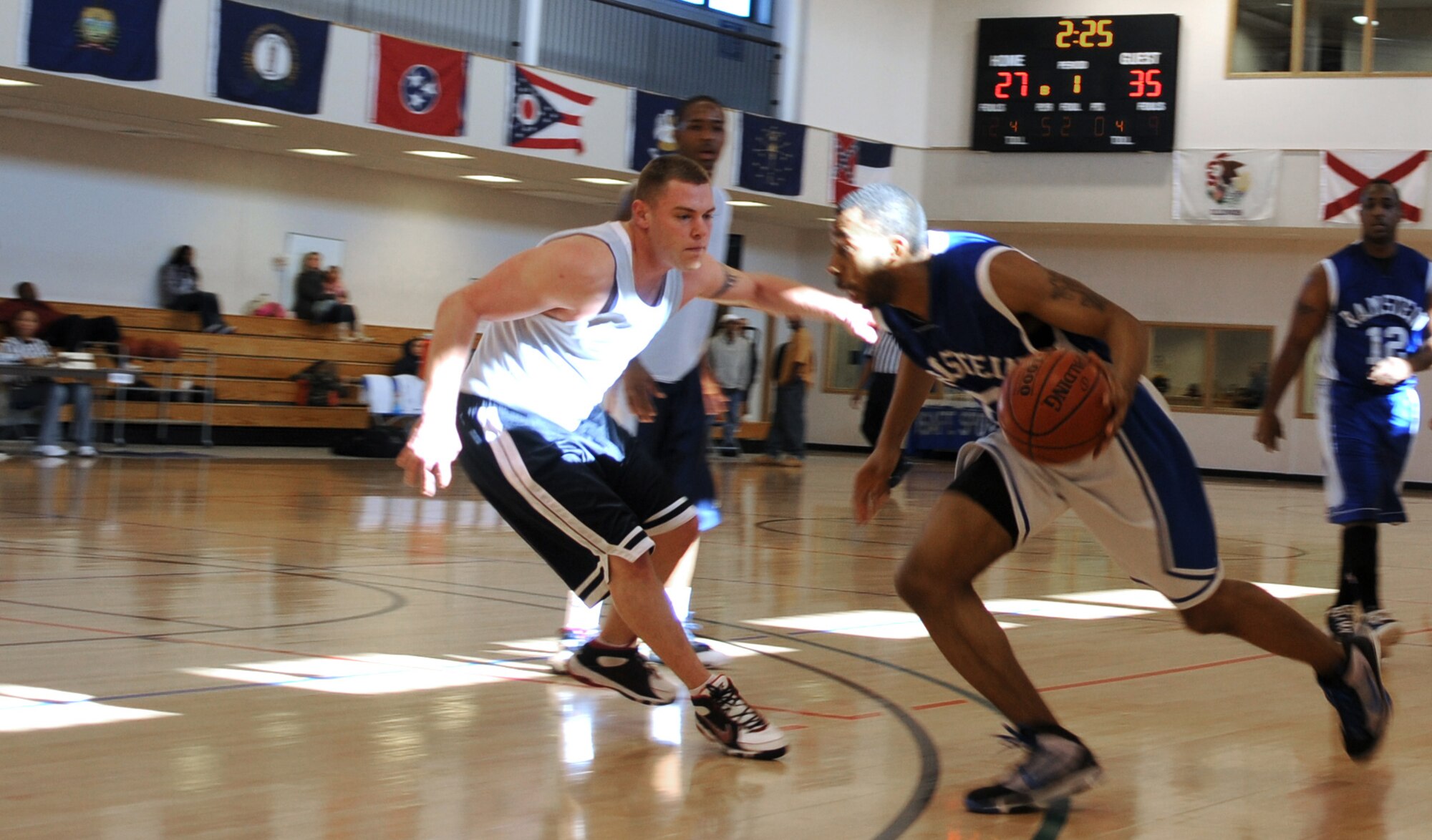 RAF MILDENHALL, England -- Aaron Stafford, 20, drives the ball past Chris Maier, 14, for the 86th Services Squadron in the 2010 U.S. Air Forces in Europe Small Unit/Intramural Basketball Championships at the Hardstand Fitness Center here March 7. The 86th Communications Squadron prevailed in the 91-86 game against the 86th SVS. Both teams are part of the 86th Airlift Wing at Ramstein Air Base, Germany. (U.S. Air Force photo/Staff Sgt. Thomas Trower)