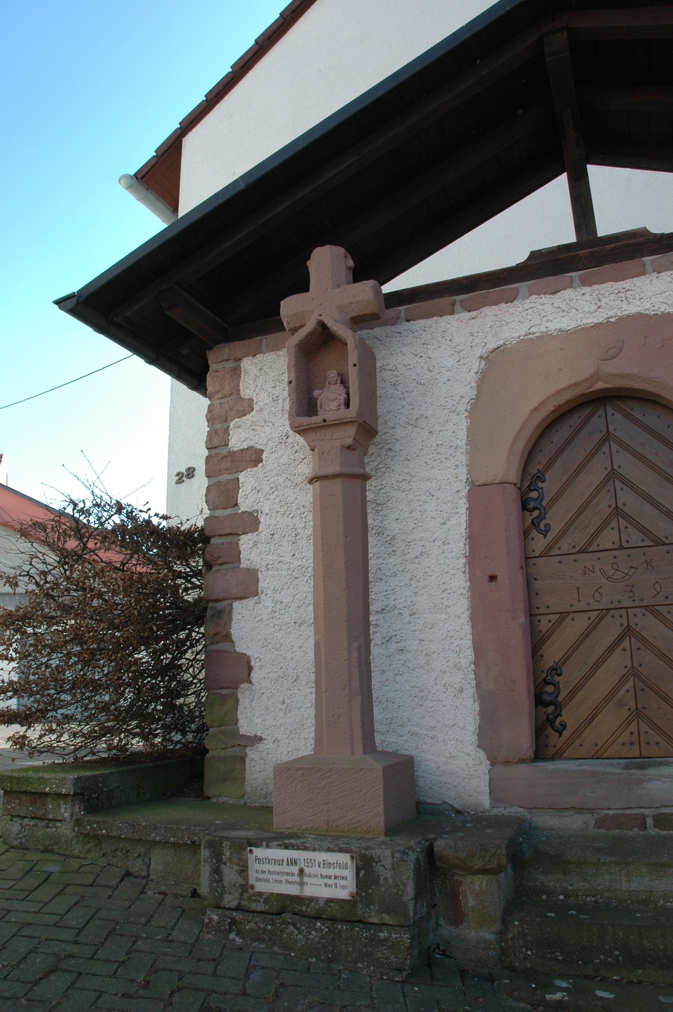 SPANGDAHLEM AIR BASE, Germany -- This cross, dating back to 1551, located on Binsfeld Georgstrasse, served as a postal station for the postal route of Liege, Belgium, and Vienna, Austria. It was here that the post wagon exchanged horses and delivered and received mail. (U.S. Air Force photo by Iris Reiff) 