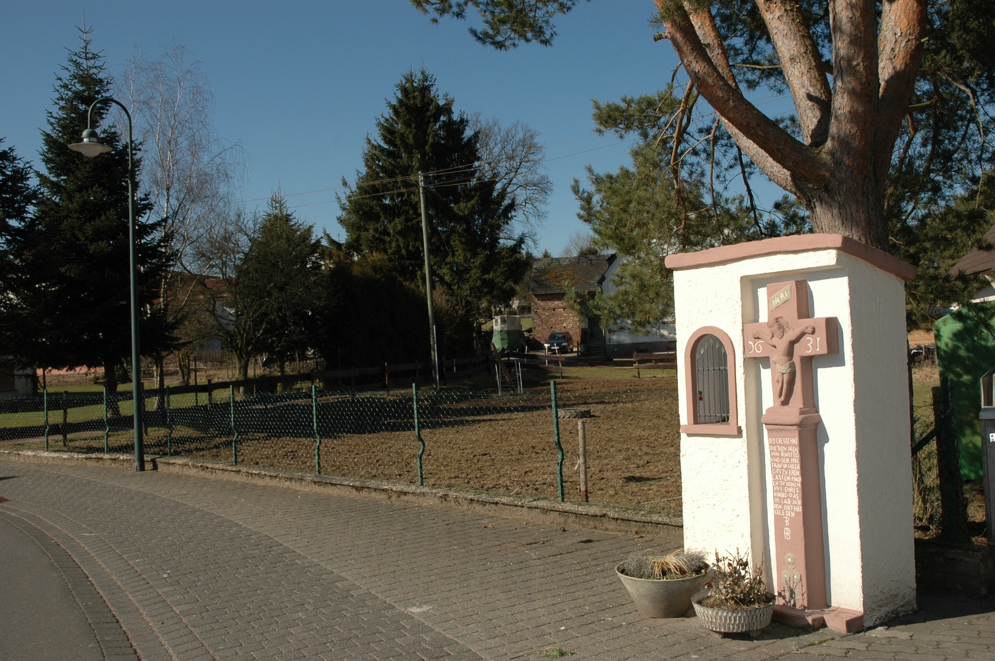 SPANGDAHLEM AIR BASE, Germany -- This cross can be found along the Binsfeld “Auf dem Aulend” road and was built in 1631 by a family with the name Dietzen. It was erected in memory of the family’s child who suffered from disease. For many years, the community prayed at the cross to protect people and animals from diseases and epidemics. They often left food at the shrine for the poor and sick. (U.S. Air Force photo by Iris Reiff)