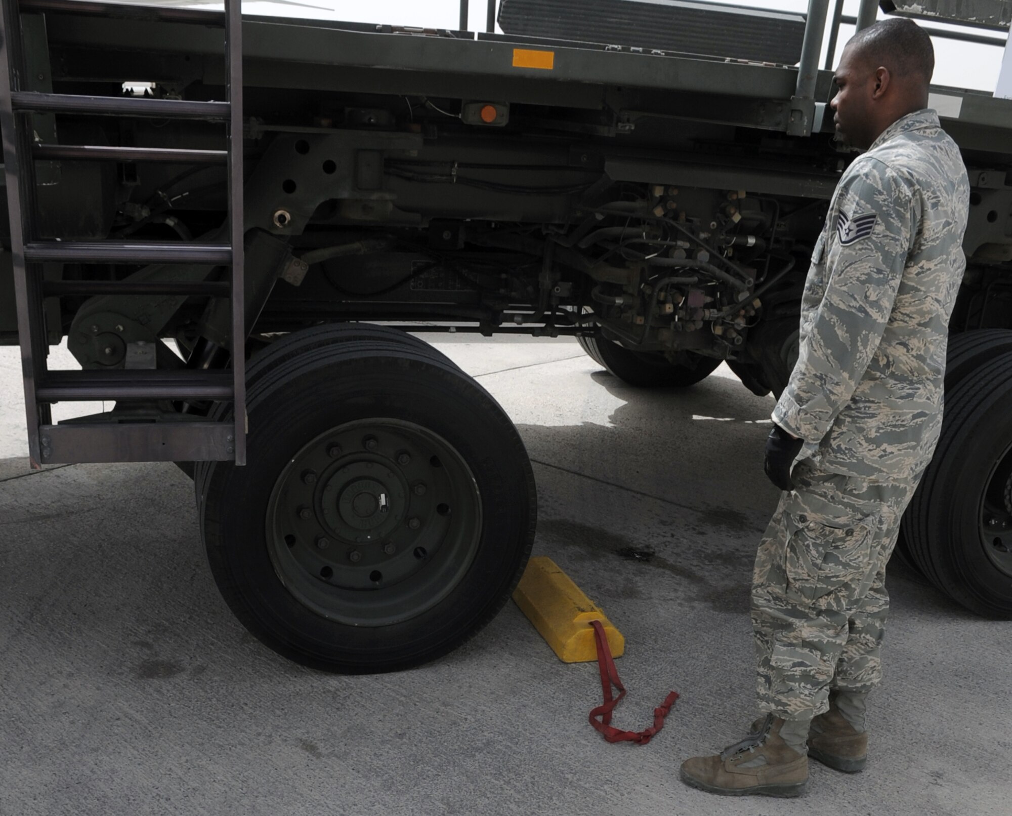 Staff Sgt. Phillip Belnavis, an air transportation craftsman with the 380th Expeditionary Logistics Readiness Squadron's Air Terminal Operations Center at a non-disclosed base in Southwest Asia, works on the 60,000-pound-capable aircraft loader during operations on the flightline of his deployed base March 1, 2010. He is deployed from the 89th Aerial Port Squadron at Andrews Air Force Base, Md., and his hometown is Pembroke Pines, Fla. (U.S. Air Force Photo/Master Sgt. Scott T. Sturkol/Released)
