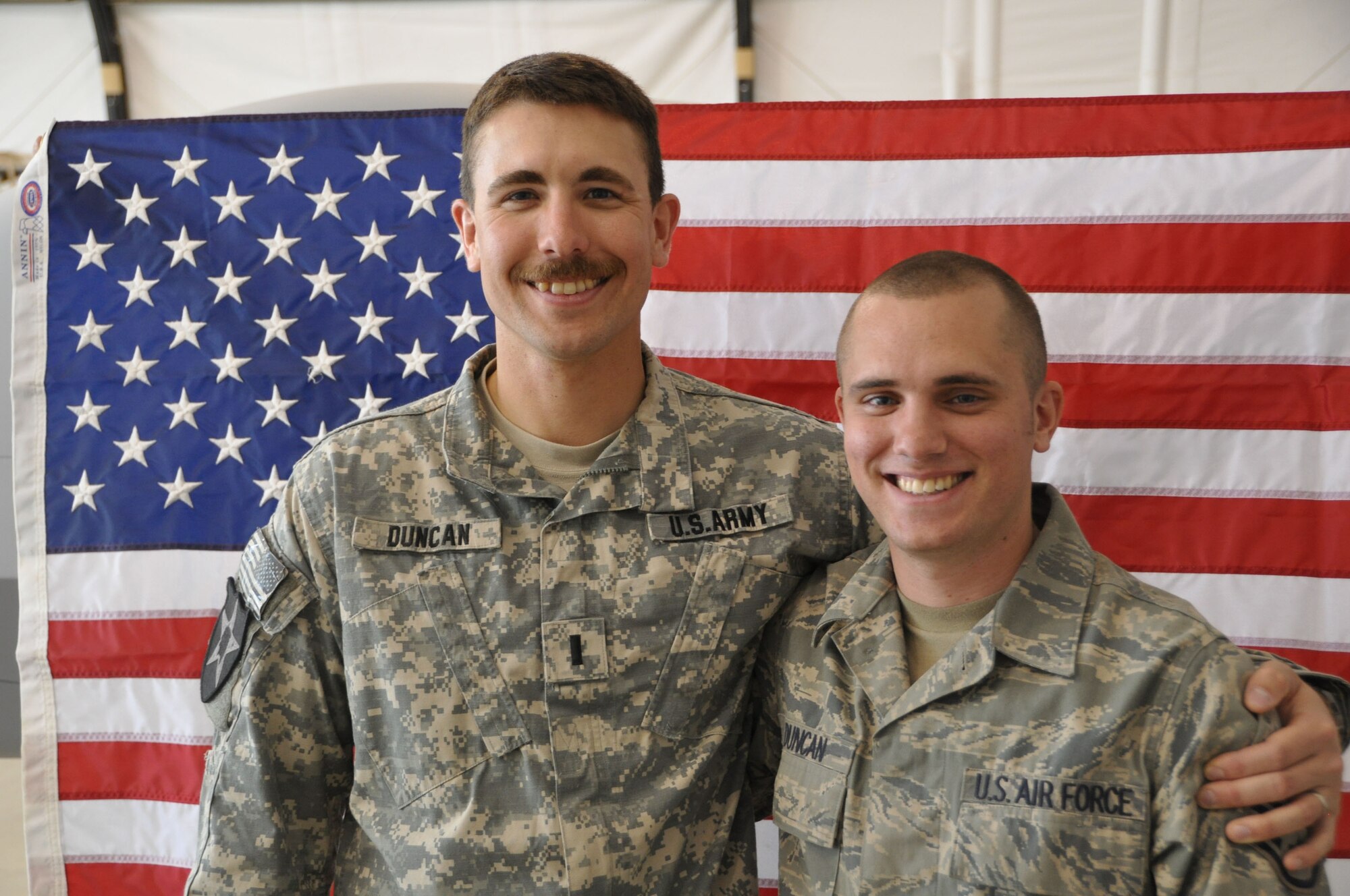 Army 2nd Lt. Jon Duncan, left, reenlisted his brother, Air Force Staff Sgt. Marc Duncan in a ceremony March 3.  (U.S. Air Force photo/Tech. Sgt. Renni Thornton/Released)