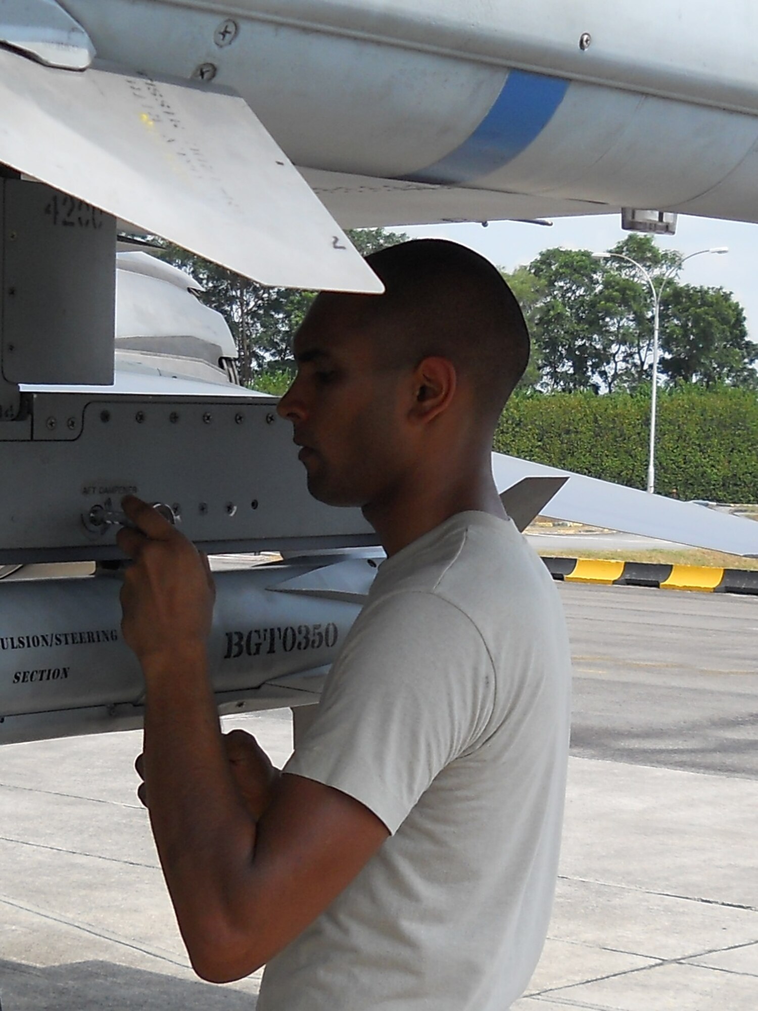 PAYA LEBAR AIR BASE, Singapore – Senior Airman Akash Ramnanan, 51st Aircraft Maintenance Squadron, loads a missile on to an F-16 Fighting Falcon during exercise Commando Sling 10. The second iteration of the exercise, which began Feb. 22, involves forces from the U.S. Air Force and the Republic of Singapore Air Force. F-16s from Osan’s 36th Fighter Squadron are participating in the exercise, conducting dissimilar air combat training with the RSAF, where different types of aircraft fly air-to air missions against each other. (Photo by Master Sgt. Bill Baker)