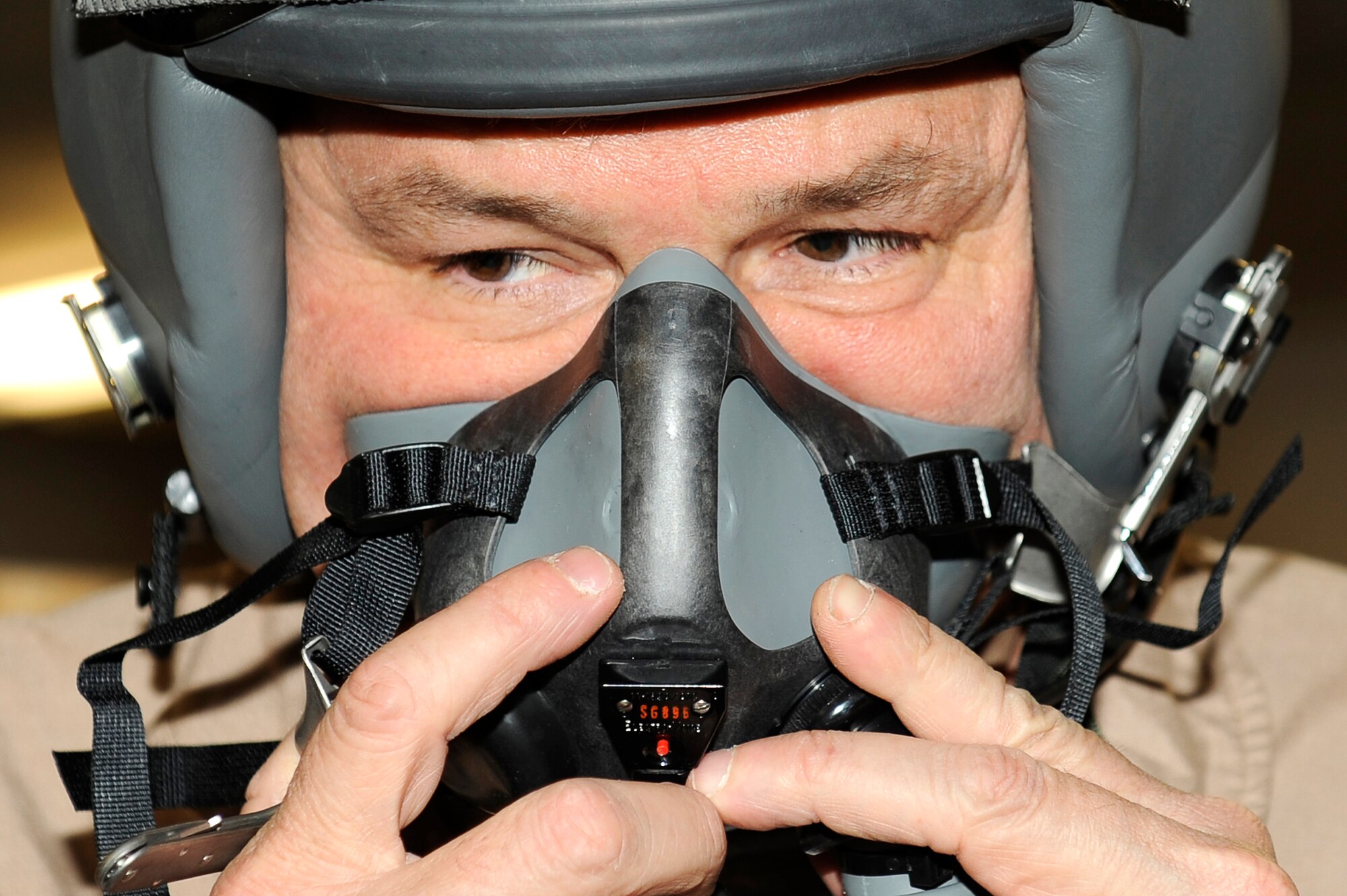 U.S. Ambassador to Afghanistan Karl Eikenberry checks the fit of his mask at Bagram Airfield, Afghanistan, March 5, 2010. Ambassador Eikenberry was at Bagram to get an orientation flight in a 494th Expeditionary Fighter Squadron F-15E Strike Eagle. (U.S. Air Force photo by/ Tech. Sgt. Jeromy K. Cross/released)