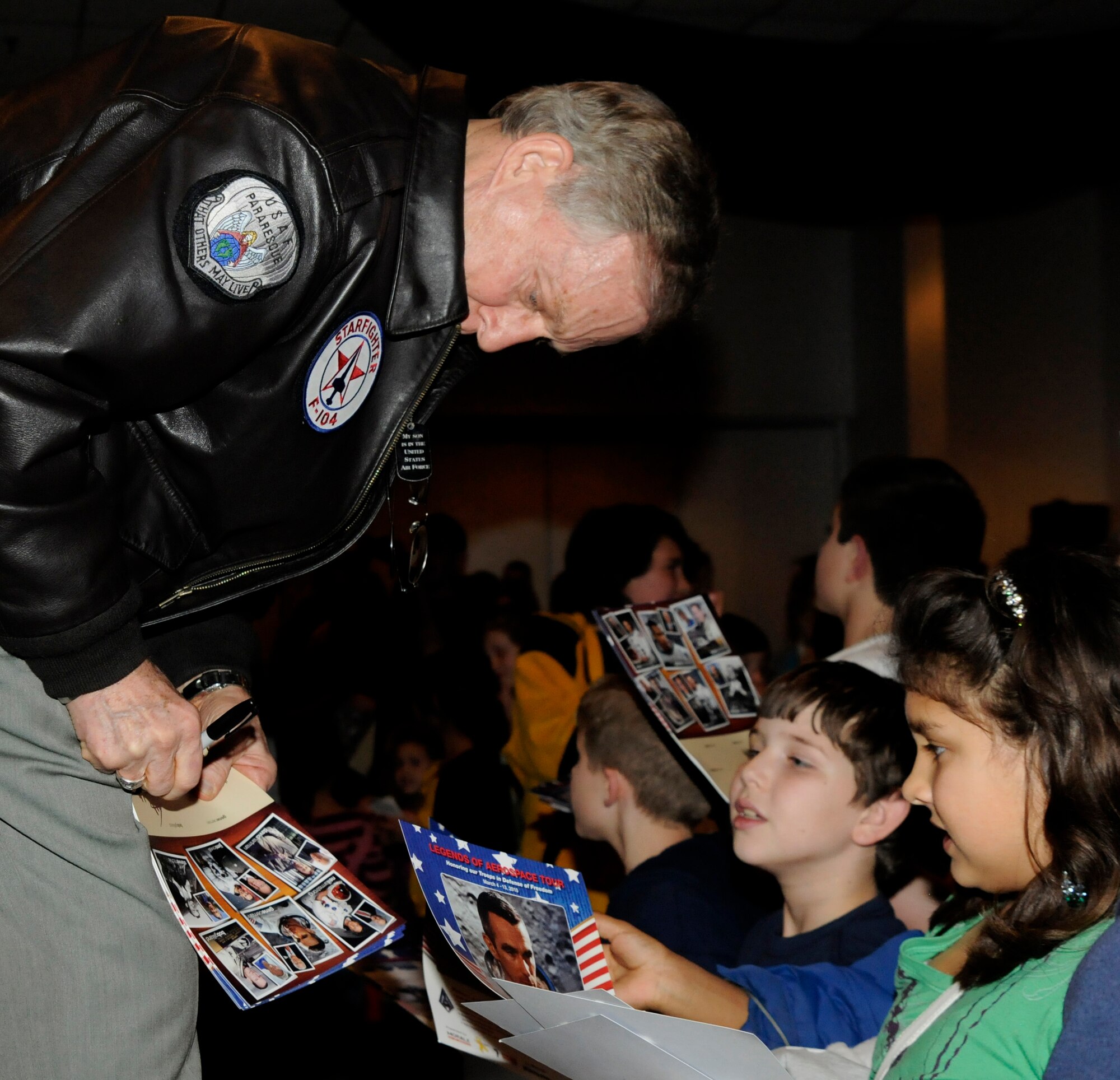 Steve Ritchie, the only United States Air Force pilot “Ace” since Korea, signs autographs for children Saturday, March 6, 2010 during the “Legends of Aerospace” tour at Incirlik Air Base, Turkey. David Hartman, retired United States Air Force officer and original Host of ABC’s Good Morning America, joined legends Neil Armstrong, Gene Cernan, Bob Gilliland, Jim Lovell and Steve Ritchie for a Morale Entertainment supported tour to meet with thousands of troops overseas and honor their defense of freedom. (U.S. Air Force photo/Airman 1st Class Amber Ashcraft)