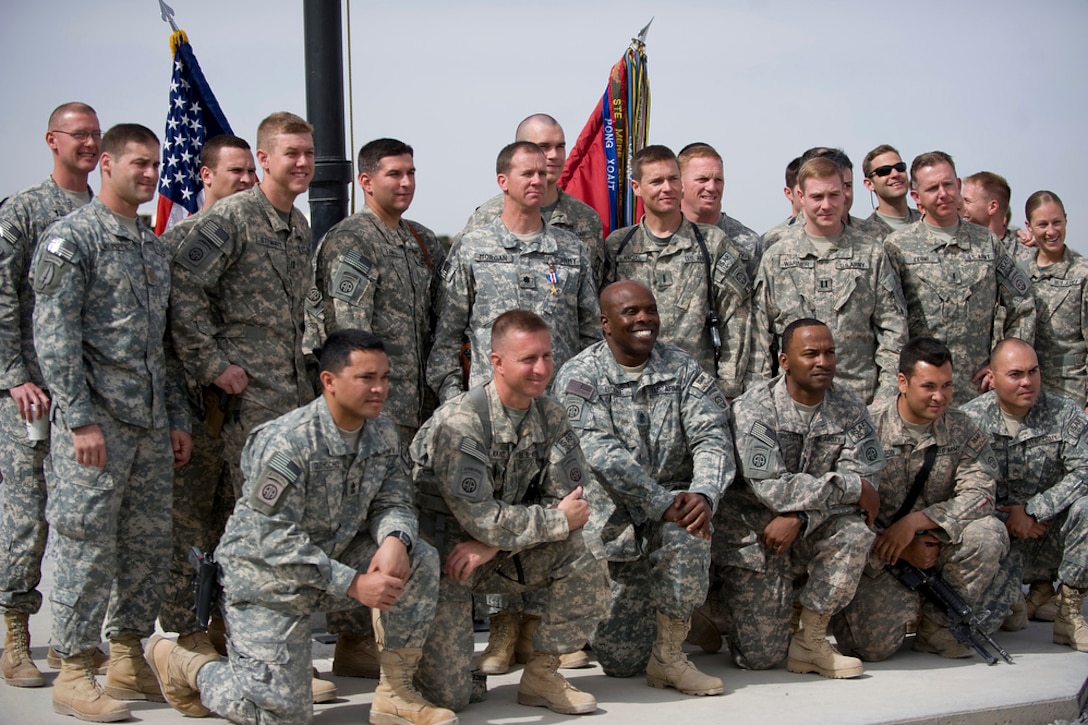 U.S. Army Lt. Col. John Morgan, center, takes a group photo with his team members after receiving the silver star of his efforts in Kandahar, Afghanistan, March 9, 2010.