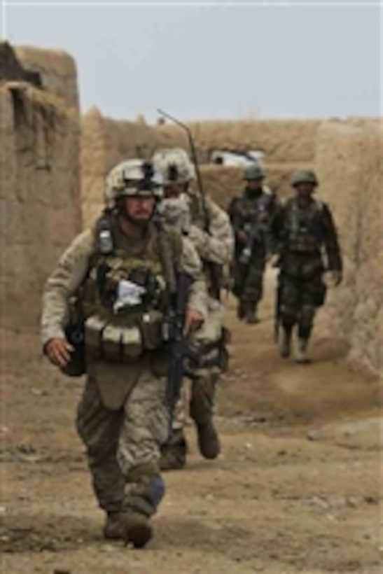 U.S. Marines with 2nd Platoon, Lima Company, 3rd Battalion, 6th Marine Regiment and Afghan soldiers arrive at their objective during Operation Helmand Spider in Badula Qulp, Helmand province, Afghanistan, on March 3, 2010.  
