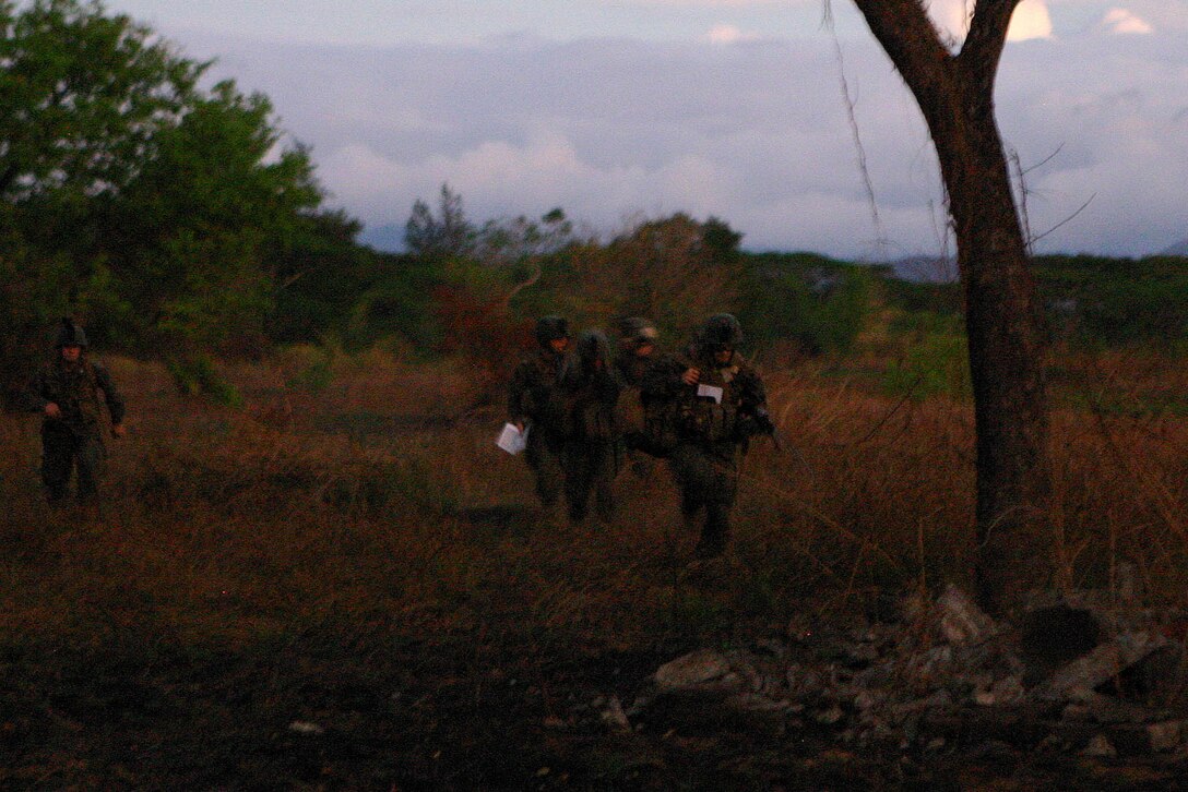 31st Marine Expeditionary Unit (MEU) Marines approach a rally point after disembarking from a CH-46E Sea Knight during a mock helicopter raid, March 10. Servicemembers from the Armed Forces of the Philippines (AFP) and the 31st Marine Expeditionary Unit (MEU) are training together during Balikatan 2010 (BK ’10) to hone their civil-military interoperability skills to ensure more responsive, efficient and effective relief efforts.