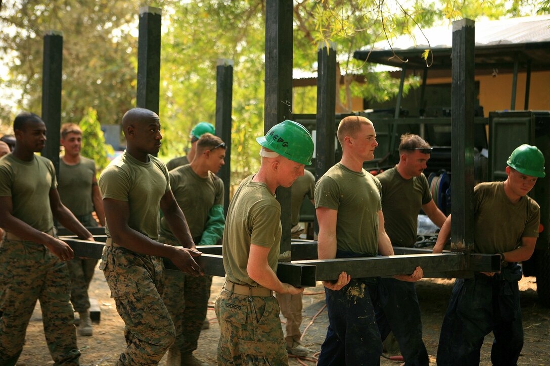 Marines with Combat Logistics Battalion 31 (CLB-31), 31st Marine Expeditionary Unit (MEU), carry a water tower frame to its base, March 10. The Armed Forces of the Philippines (AFP) and CLB-31, 31st MEU, servicemembers work together in rebuilding a two-room classroom and a water tower at Marnay Primary School during exercise Balikatan 2010 (BK ’10).
