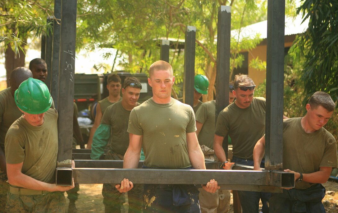 Marines with Combat Logistics Battalion 31 (CLB-31), 31st Marine Expeditionary Unit (MEU), carry a water tower frame on to its base, March 10. The Armed Forces of the Philippines (AFP) and CLB-31, 31st MEU, servicemembers work together in rebuilding a two-room classroom and a water tower at Marnay Primary School during exercise Balikatan 2010 (BK ’10).