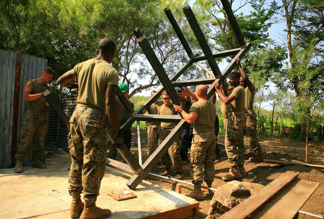Marines with Combat Logistics Battalion 31 (CLB-31), 31st Marine Expeditionary Unit (MEU), carry a water tower frame on to base, March 10. The Armed Forces of the Philippines (AFP) and CLB-31, 31st MEU, servicemembers work together in rebuilding a two-room classroom and a water tower at Marnay Primary School during exercise Balikatan 2010 (BK ’10).