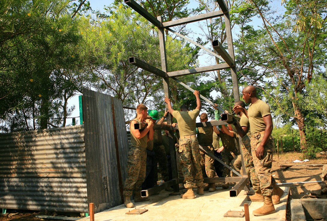 Marines with Combat Logistics Battalion 31 (CLB-31), 31st Marine Expeditionary Unit (MEU), place a water tower frame on its base, March 10. The Armed Forces of the Philippines (AFP) and CLB-31, 31st MEU, servicemembers work together in rebuilding a two-room classroom and a water tower at Marnay Primary School during exercise Balikatan 2010 (BK ’10).