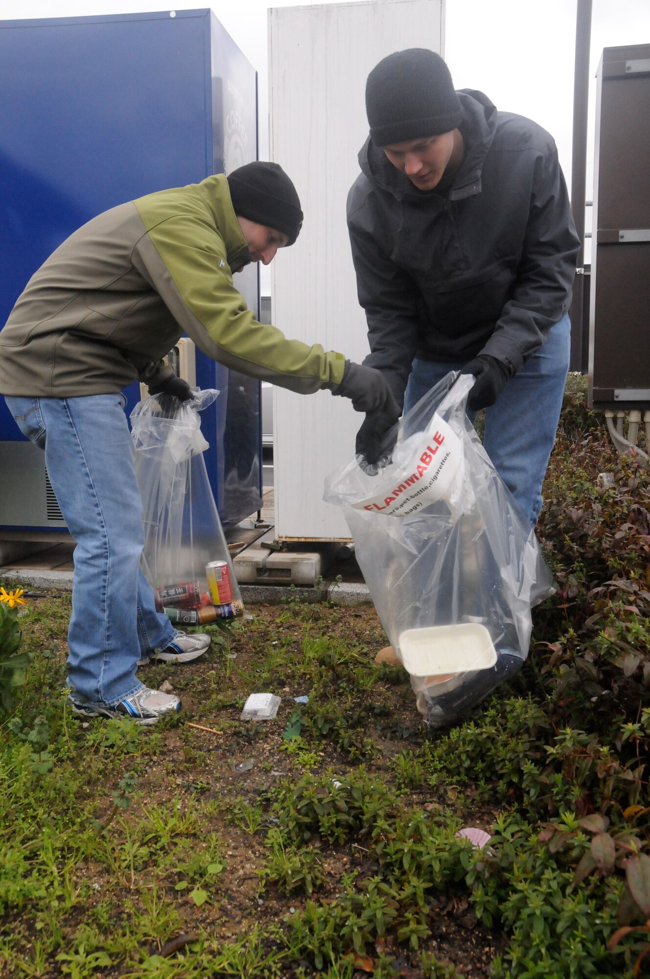 TSUIKI CITY, Japan ? Capt. Peter Pleake-Tamm, 35th Civil Engineer Squadron, and Capt. Matt Kenkel, 14th Fighter Squadron, pick up trash at a park just outside the base March 9, 2010. Approximately 90 Airmen are at Tsuiki to participate in an aviation training relocation exercise. (U.S. Air Force photo/Staff Sgt. Rachel Martinez)