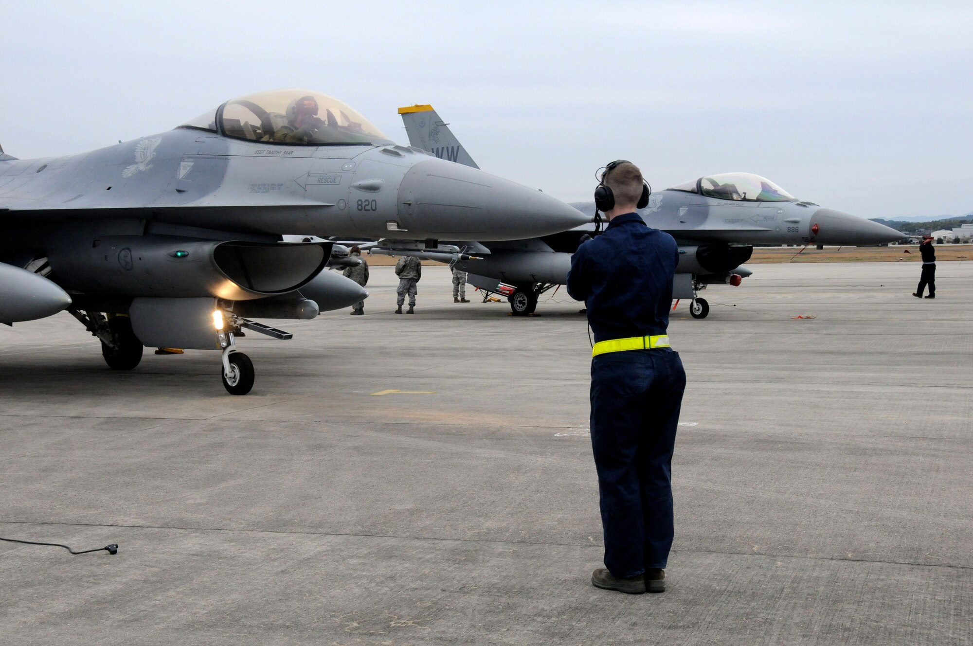 TSUIKI AIR BASE, Japan ? A crewchief from the 14th Fighter Squadron, marshals in an F-16 Fighting Falcon March 8. Five F-16s and approximately 90 Airmen from Misawa Air Base are participating in an aviation training relocation exercise with the Japan Air Self-Defense Force March 8-12. (U.S. Air Force photo/Staff Sgt. Rachel Martinez)
