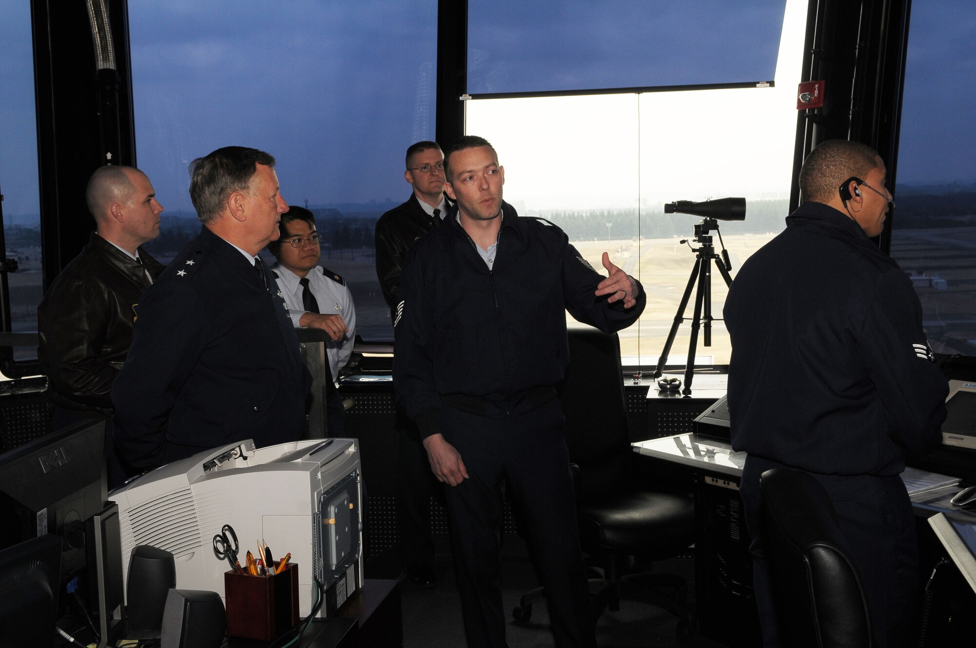 YOKOTA AIR BASE, Japan -- Assistant chief controller,Technical Sgt. Eric Epperson, 374th Operations Support Squadron (center), briefs  Maj. Gen. Frederick Roggero, Air Force Chief of Safety, about the daily activities in the Air Traffic Control Tower Mar. 8. Gen. Roggero visited Yokota during his tour of Pacific Air Bases. (U.S. Air Force/Airman 1st Class Sean Martin)