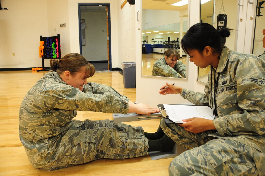 ELLSWORTH AIR FORCE BASE, S.D. -- (Left to right) Airman Kaitlin Walker, 28th Bomb Wing radio and television broadcaster, tests her flexibility as Airman 1st Class Elimae Gilchrist, 28th Force Support Squadron fitness specialist, tracks her results during a fitness assessment, March 9.  Improved flexibility puts less strain on the body during workout sessions. (U.S. Air Force photo/Airman 1st Class Anthony Sanchelli)