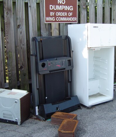 An improperly disposed of microwave, treadmill and refrigerator were dumped at the paint storage yard across from the Auto Hobby Shop. Dumping on base is strictly prohibited by the installation commander. (Courtesy photo)