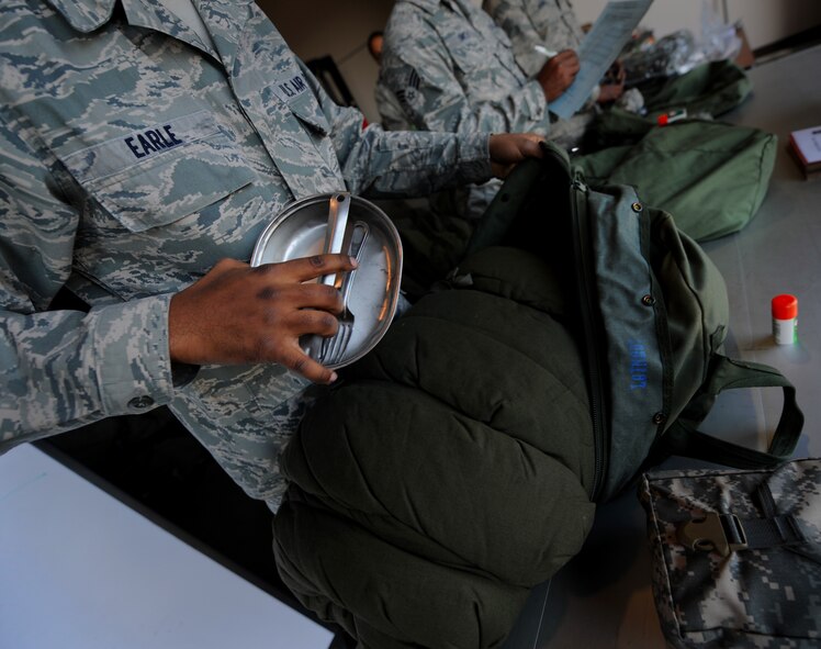 MOODY AIR FORCE BASE, Ga. -- Airman 1st Class Zachariah Earle, 23rd Logistics Readiness Squadron individual protection equipment section, puts supplies into a mobility bag before handing it to a deploying member during a Phase I Operational Readiness Inspection here March 9. Members from the Air Combat Command Inspection General team, Langley Air Force Base, Va., are inspecting the wing’s ability to deploy its personnel and assets on a short notice deployment tasking. (U.S. Air Force photo by Senior Airman Gina Chiaverotti-Paige)