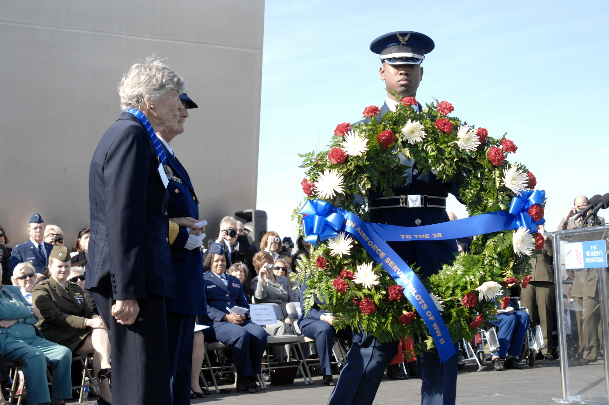 Dawn Seymour and retired Coast Guard Vice Adm. Vivien S. Crea are presented a wreath by a member of the Air Force Honor Guard March 9, 2010, in Arlington, Va., to honor the 38 WASP who lost their lives in the line of duty. (U.S. Air Force photo/Senior Master Sergeant Kim Allain) 