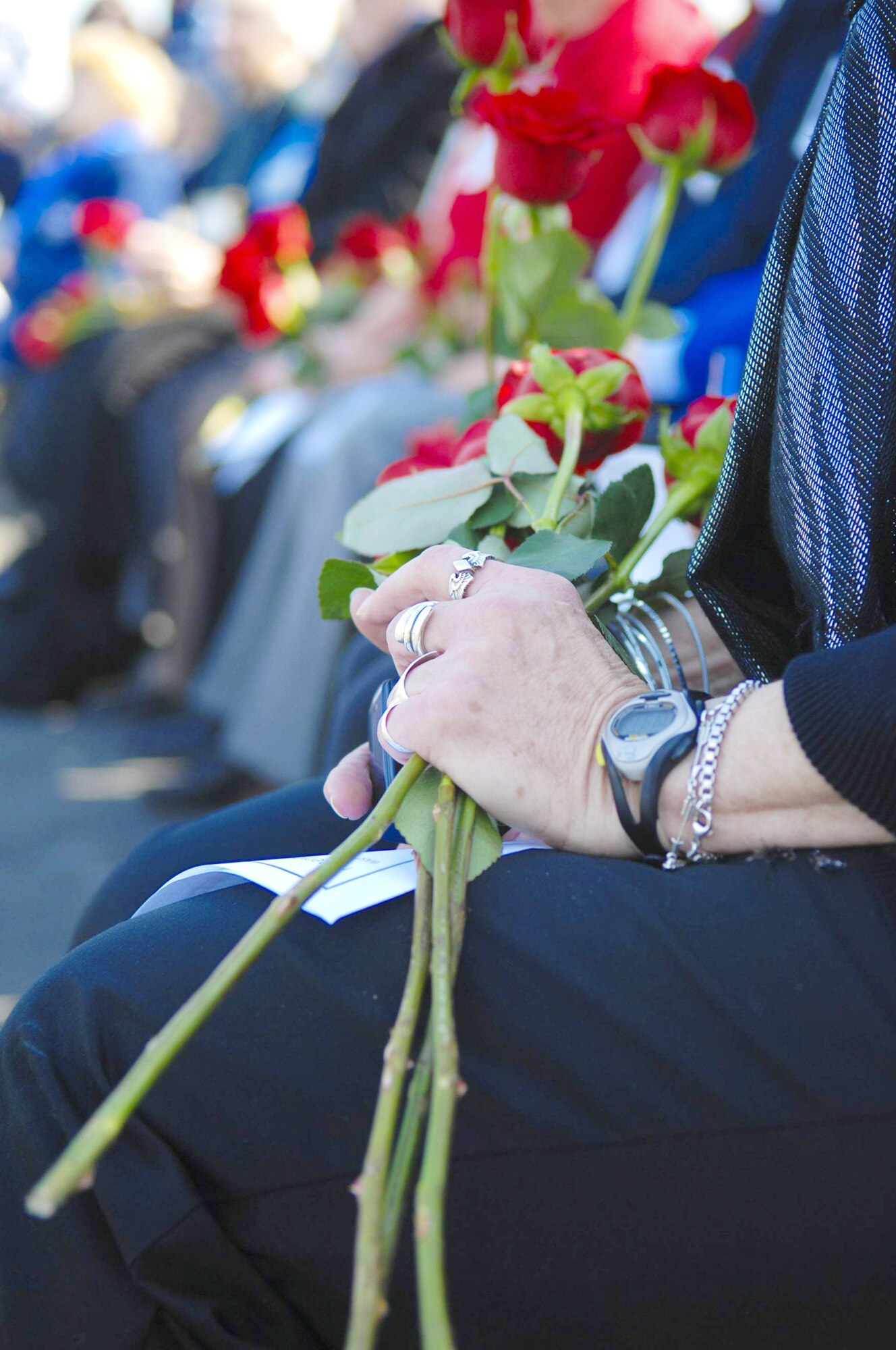 A family member of a Women Airforce Service Pilot clutches roses that represent a WASP pilot who has passed away during a ceremony March 9, 2010 in Arlington, Va. (U.S. Air Force photo/Staff Sgt. Erica J. Knight)