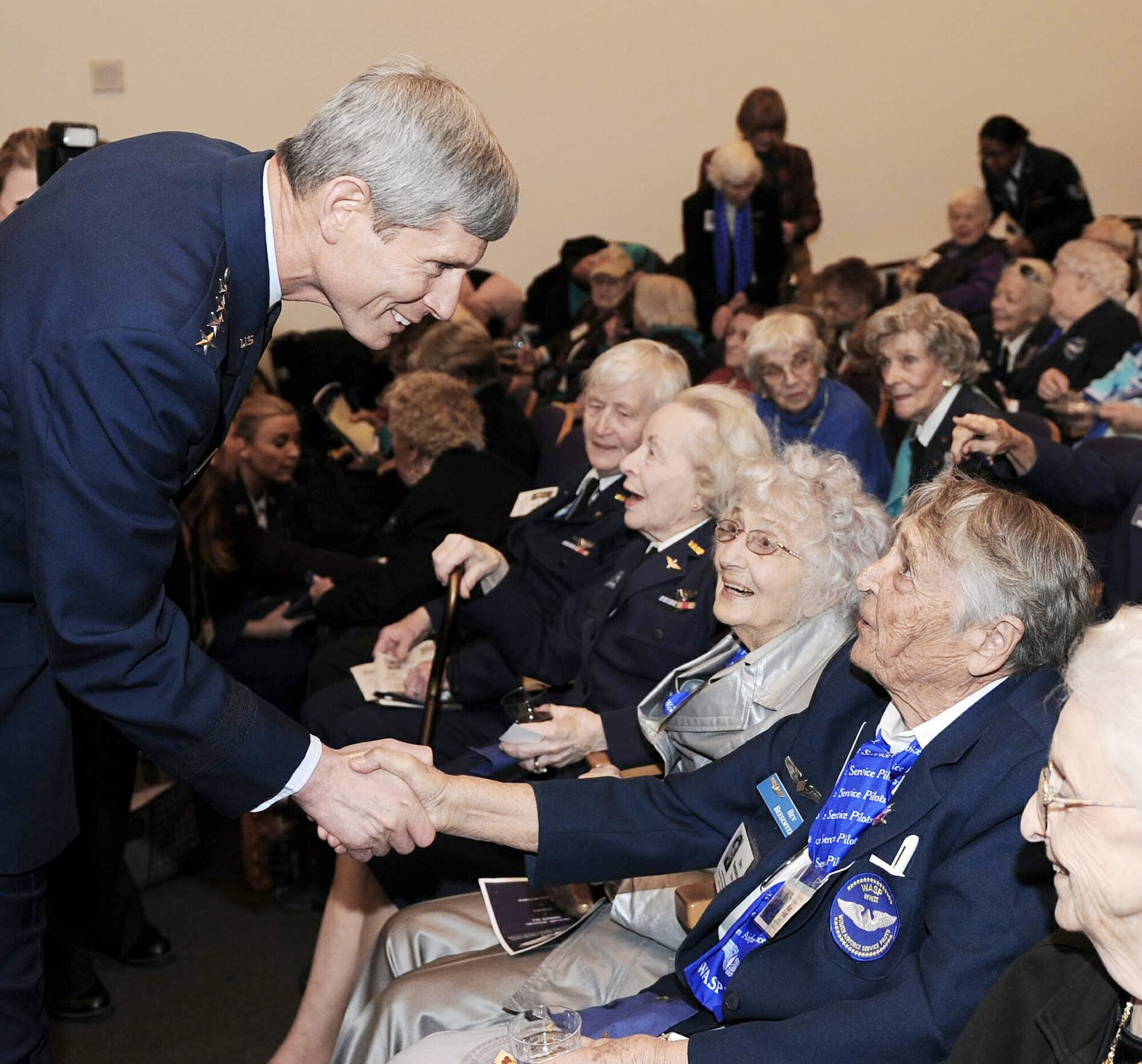 Chief of Staff of the Air Force Gen. Norton Schwartz shakes hands March 10, 2010, with Bev Bessemyer during a reception at the Women in Military Service to America Memorial in Arlington, Va. U.S. Air Force photo by Andy Morataya)