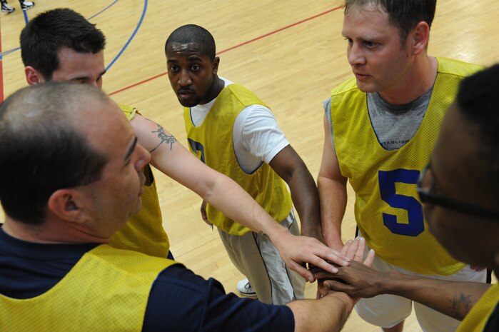 Members of the 437th Operations Support Squadron basketball team perform a chant during a game held at the Fitness and Sports Center here March 9. There are currently 16 teams competing for the base championship during this season, which will come to an end in early April. (U.S. Air Force photo/Senior Airman Katie Gieratz)