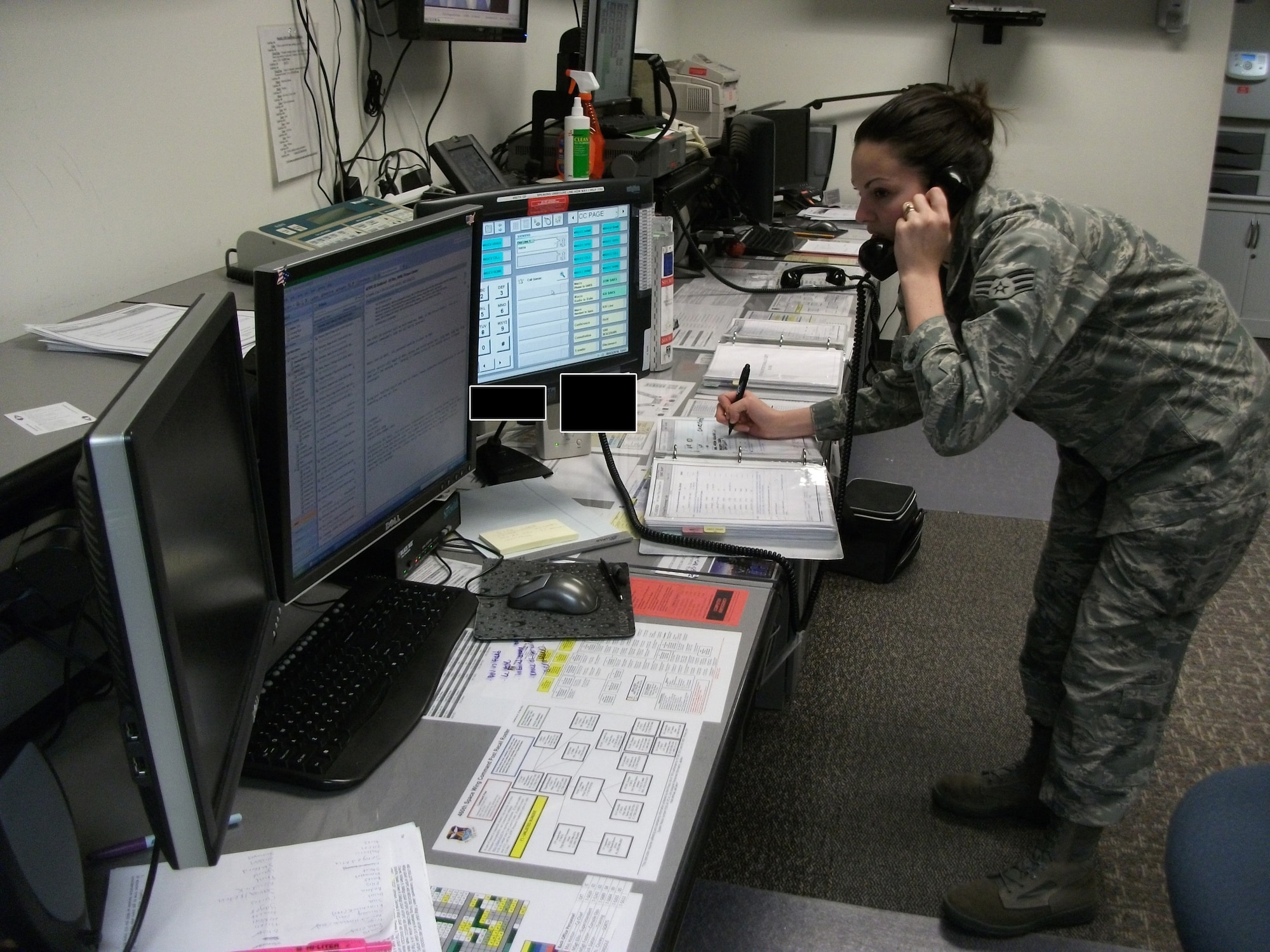 BUCKLEY AIR FORCE BASE, Colo. -- Senior Airman Darlene Slaton, 460th Space Wing Command Post, multitasks during the recent Operational Readiness / Unit Compliance Inspection Major Accident Response Exercise. Airman Slaton was one of several Team Buckley Professional Performers during the ORI/UCI. (U.S. Air Force photo by Master Sgt. Lonnie Ellis)