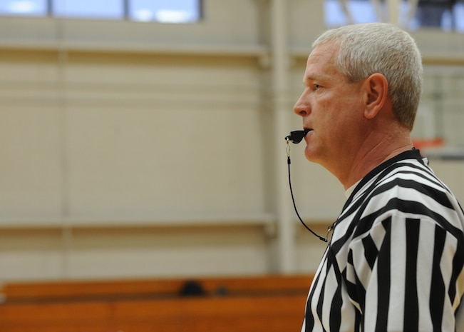 Will Hamm referees an intramural basketball game held at the Fitness and Sports Center here March 9. There are currently 16 teams competing for the base championship during this season, which will come to an end in early April. Hamm was the head referee for the game. (U.S. Air Force photo/Senior Airman Katie Gieratz)
