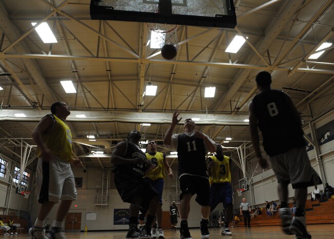 Geoffery Smart reaches for the ball during an intramural basketball game held at the Fitness and Sports Center here March 9. The 628th Security Forces Squadron won the game against the 437th Operations Support Squadron 41-36. Smart is with the 628 SFS. (U.S. Air Force photo/Senior Airman Katie Gieratz)