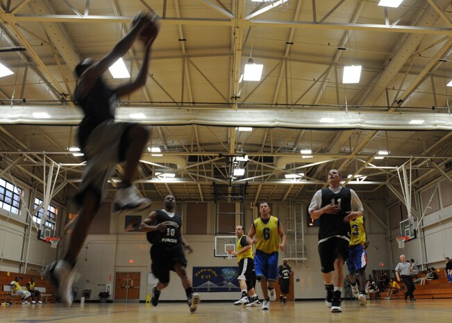 Gregory Bouie performs a layup during an intramural basketball game held at the Fitness and Sports Center here March 9. The 628th Security Forces Squadron outlasted the 437th Operations Support Squadron 41-36. Bouie is with the 628 SFS. (U.S. Air Force photo/Senior Airman Katie Gieratz)