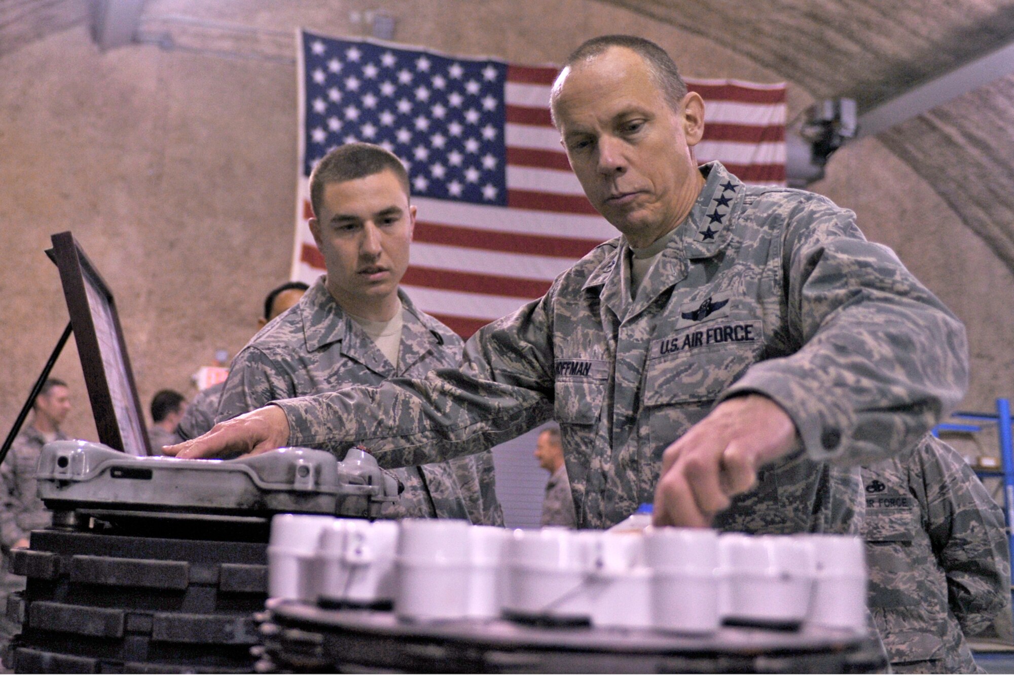 Gen. Donald J. Hoffman (right), examines two aircraft brakes while Senior Airman Stephen Baumgart explains his mission at a location in Southwest Asia. General Hoffman is the commander of the Air Force Materiel Command and Airman Baumgart is assigned to the 379th Expeditionary Maintenance Squadron. (U.S. Air Force photo/Senior Airman Kasey Zickmund)