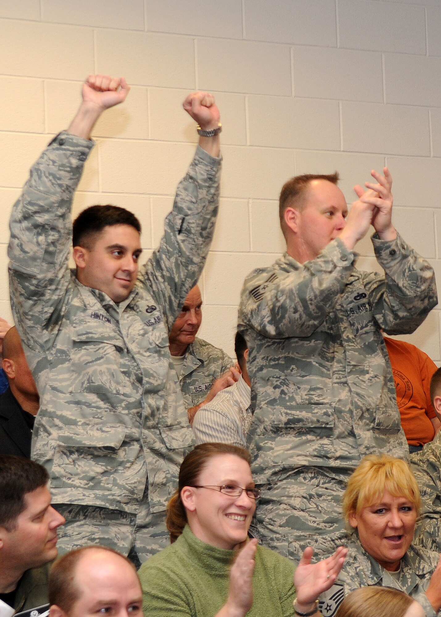 BUCKLEY AIR FORCE BASE, Colo. -- Maj. Ben Hinton and Tech. Sgt. Ronald Brown, 460th Space Wing Command Post, cheer during the Operational Readiness / Unit Compliance Inspection outbrief March 10. Team Buckley passed the no-notice ORI/UCI with a satisfactory rating. ( U.S. Air Force Photo by Airman 1st Class Marcy Glass )




