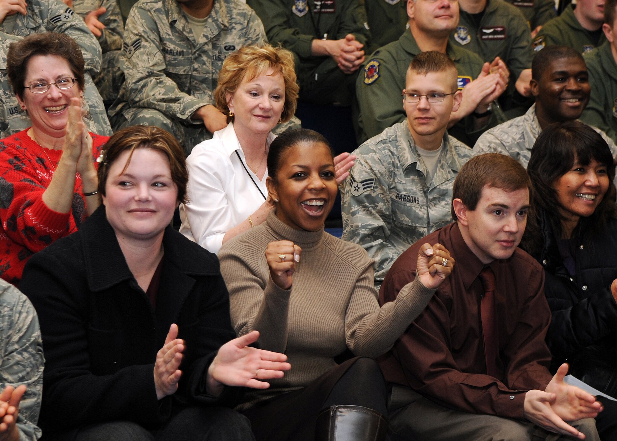 BUCKLEY AIR FORCE BASE, Colo. -- 460th Space Wing staff applaud during the Operational Readiness / Unit Compliance Inspection outbrief March 10. Team Buckley passed the no-notice ORI/UCI with a satisfactory rating. ( U.S. Air Force Photo by Airman 1st Class Marcy Glass )


