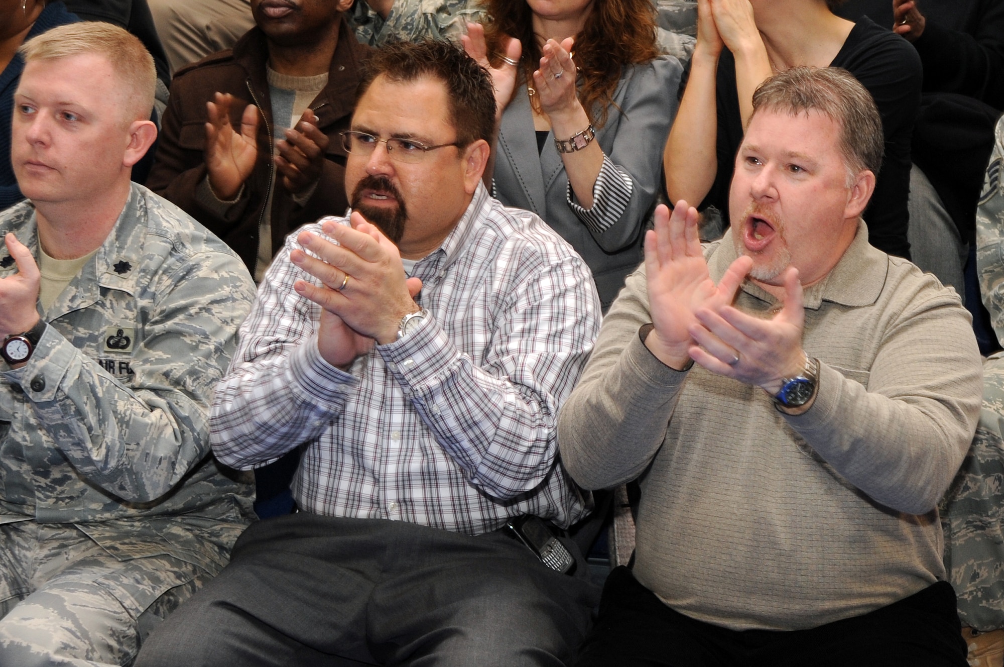 BUCKLEY AIR FORCE BASE, Colo. -- 460th Contracting Squadron staff cheer during the Operational Readiness / Unit Compliance Inspection outbrief March 10. Team Buckley passed the no-notice ORI/UCI with a satisfactory rating. ( U.S. Air Force Photo by Airman 1st Class Marcy Glass )




